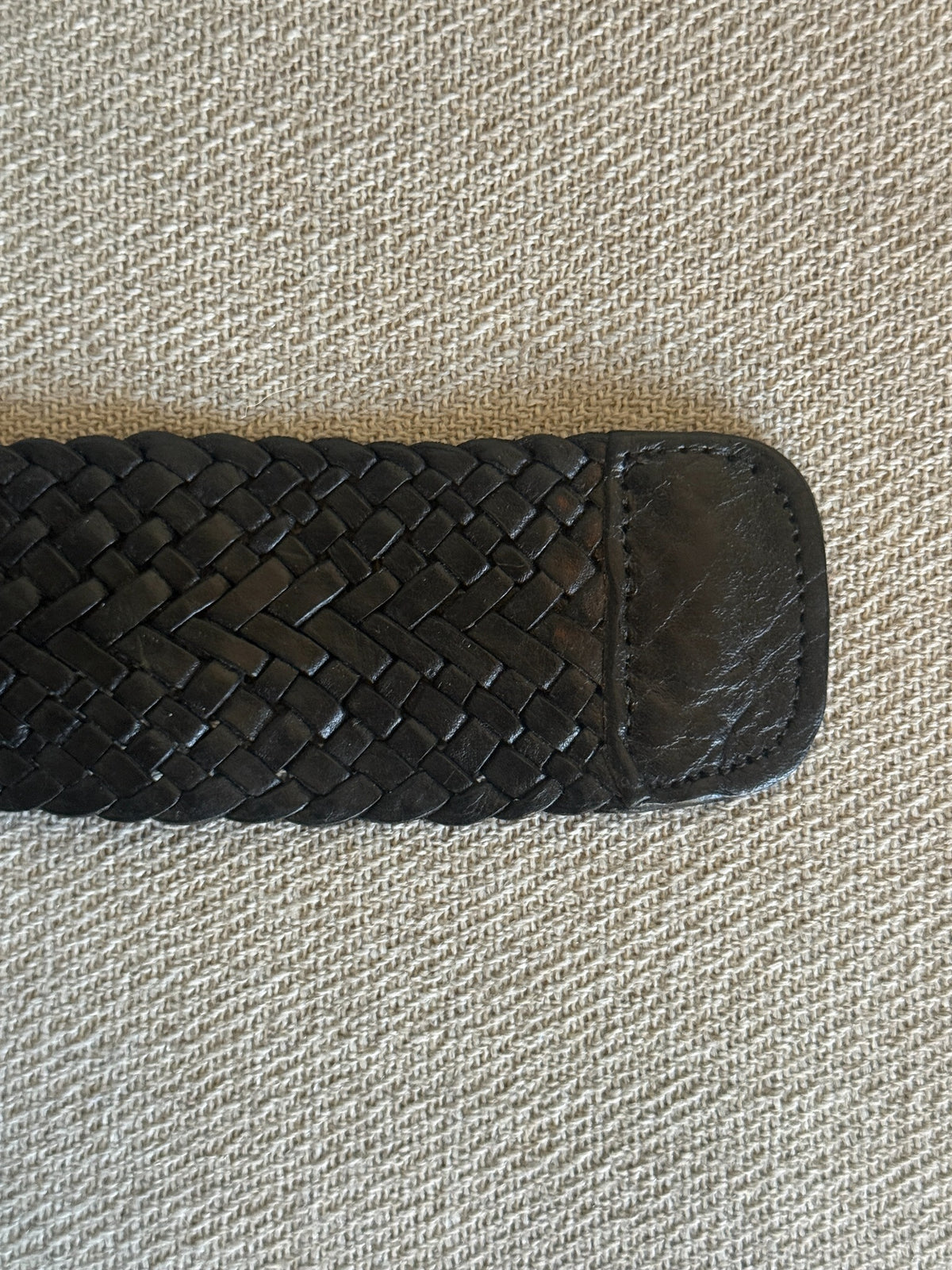 Black braided leather belt and oversized round hammered silver-tone buckle