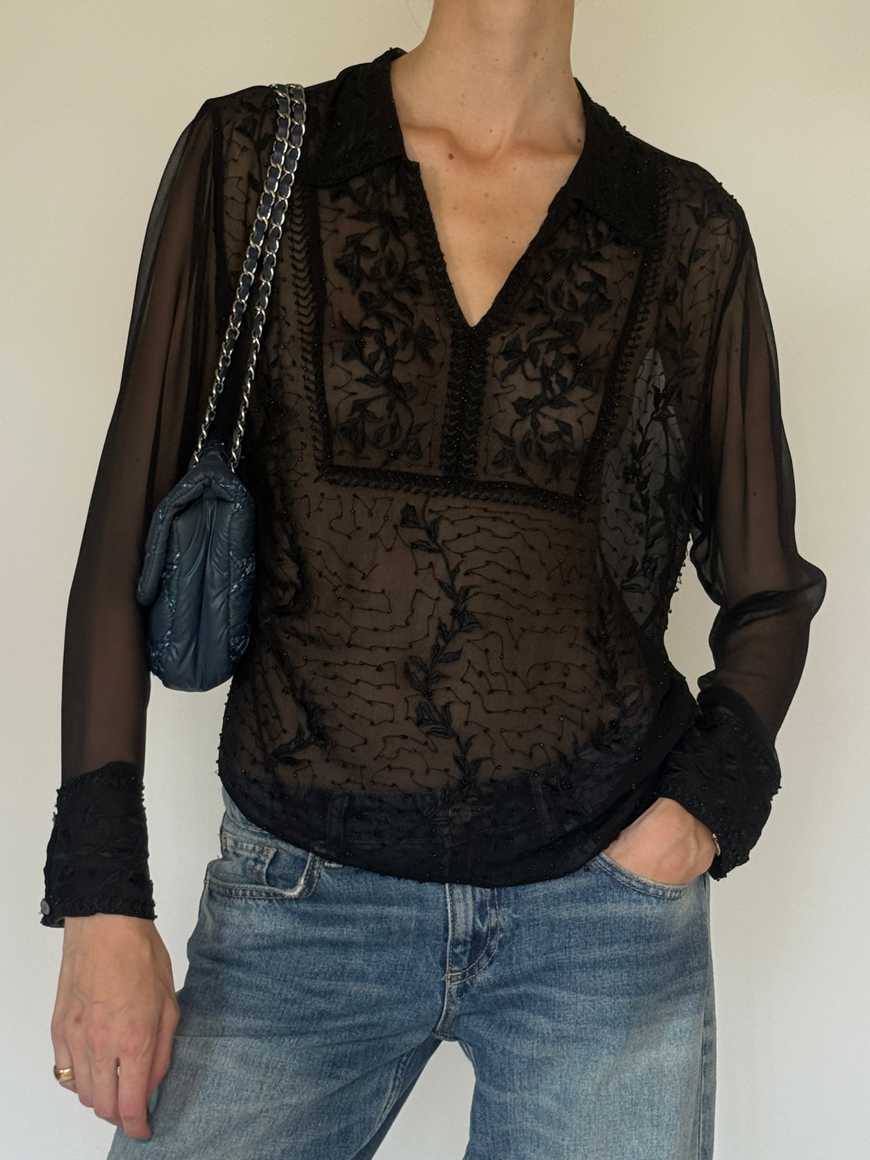 Vintage sheer black embroidered blouse close-up of floral embroidery