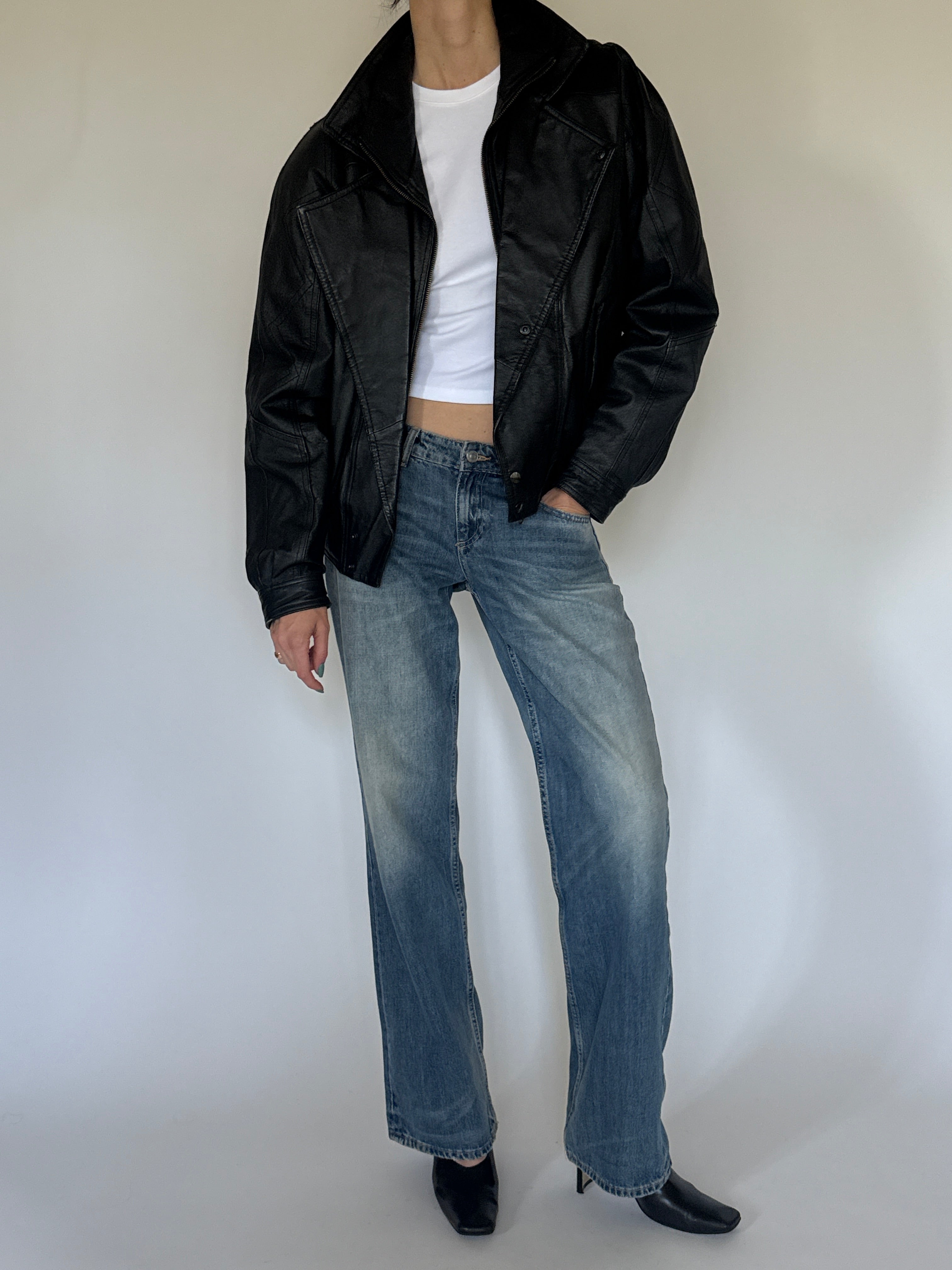Vintage oversized black leather bomber jacket leather texture close-up