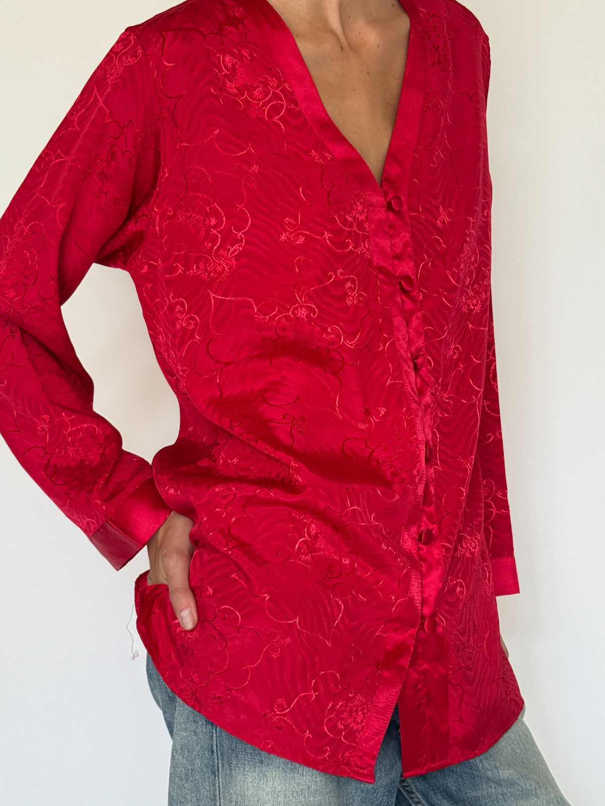Vintage red jacquard blouse fabric and button detail