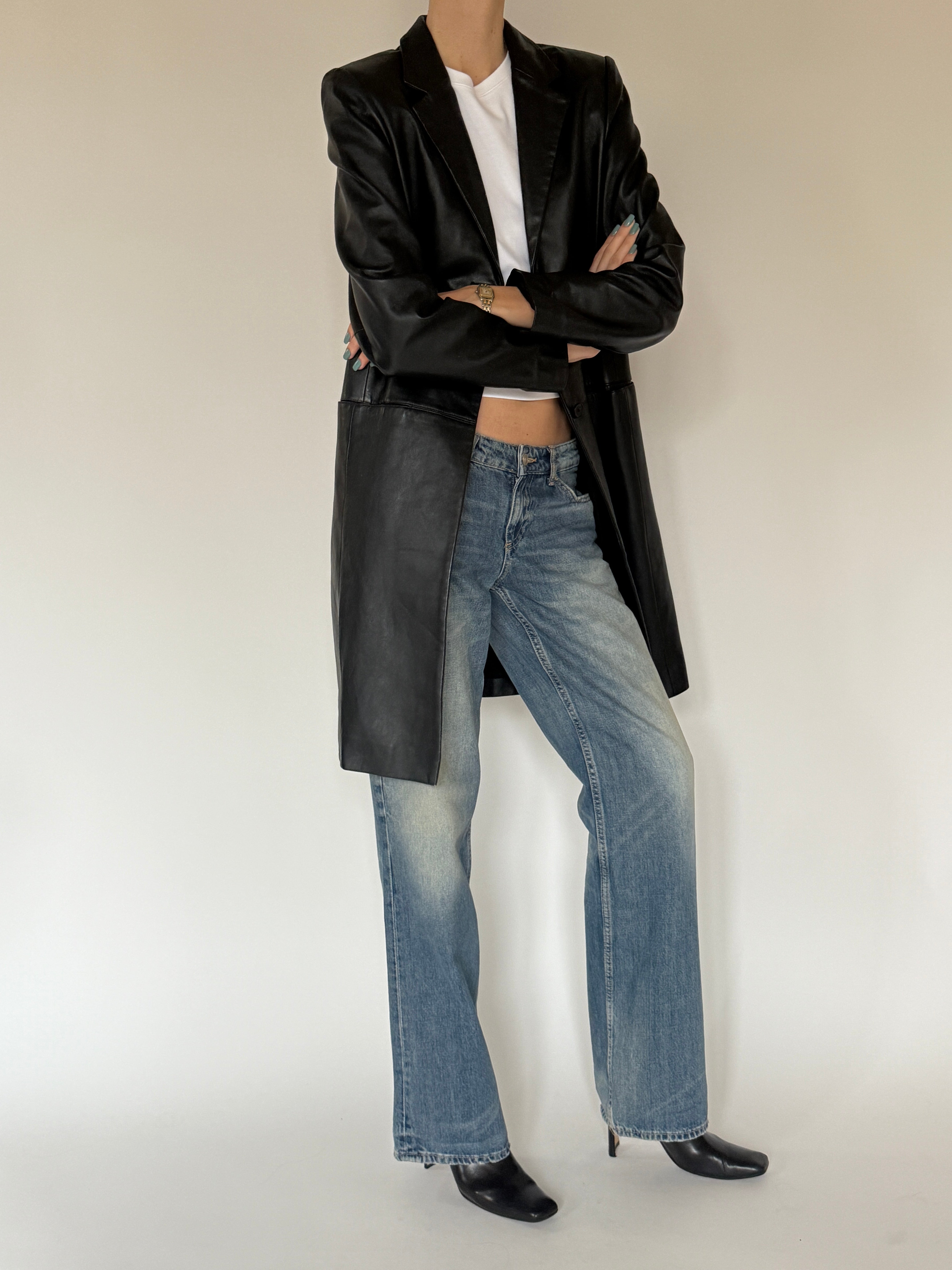 Vintage black leather jacket styled with denim