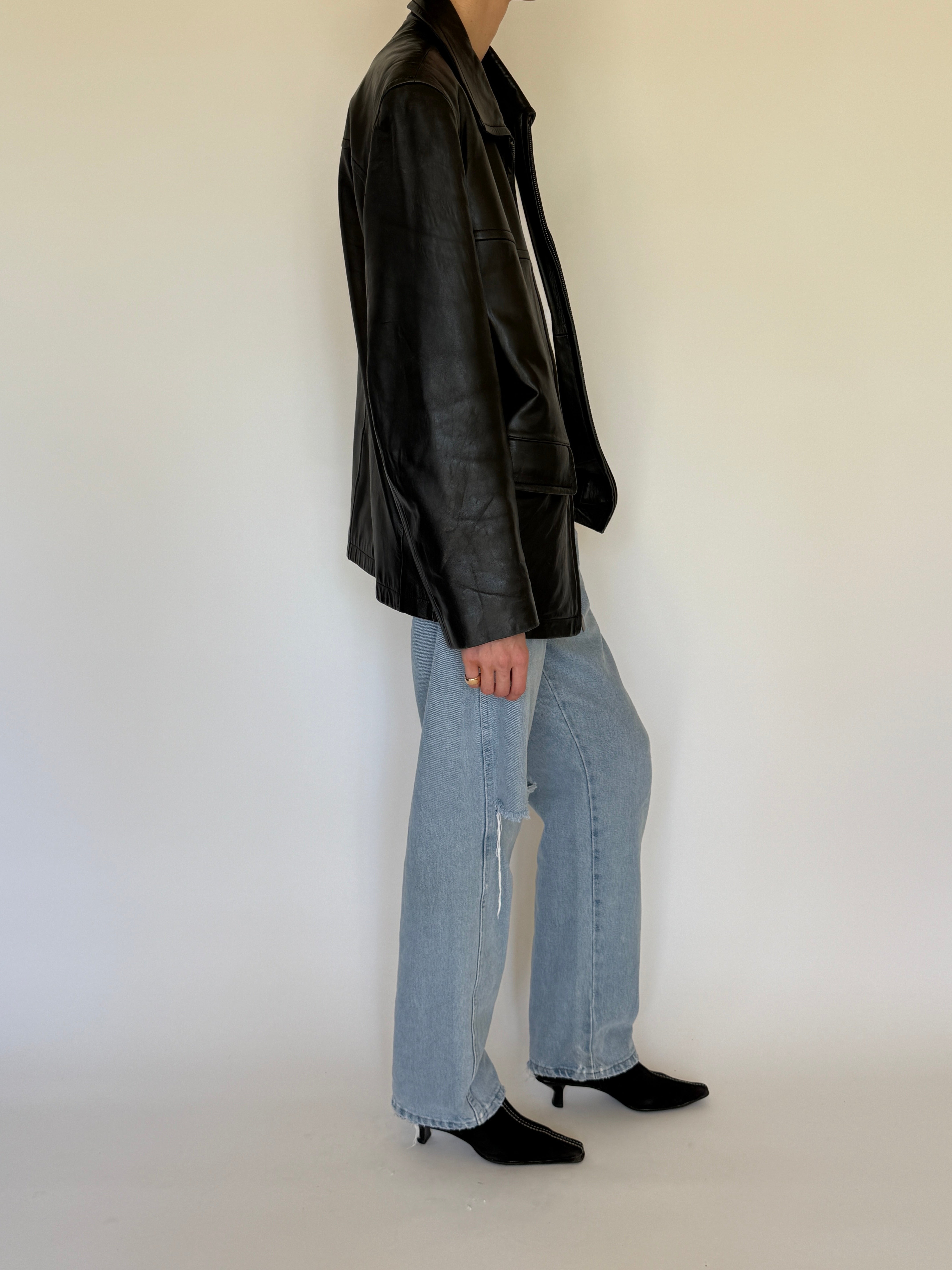 Vintage black leather jacket side view