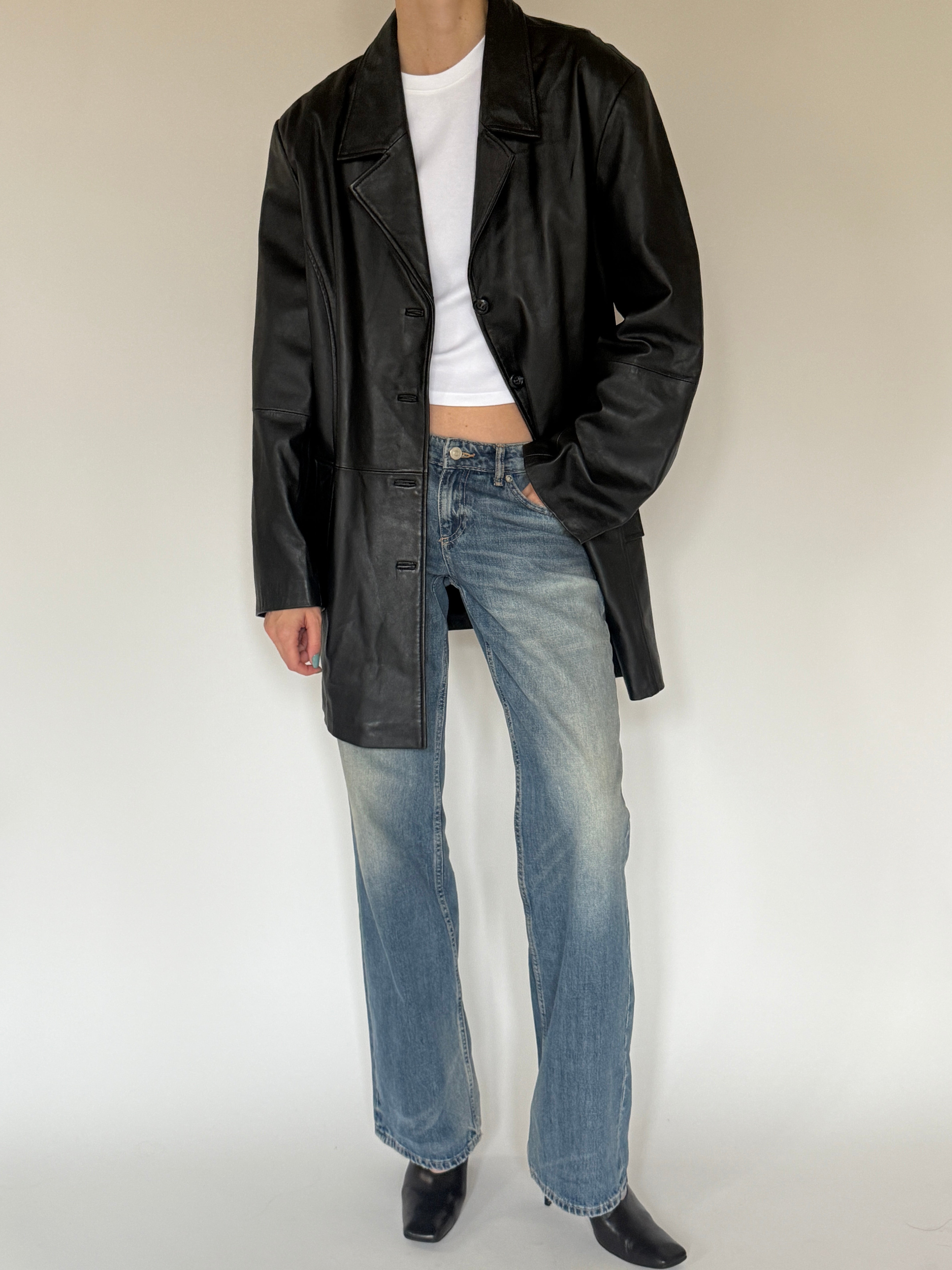 Vintage classic black leather jacket angled view