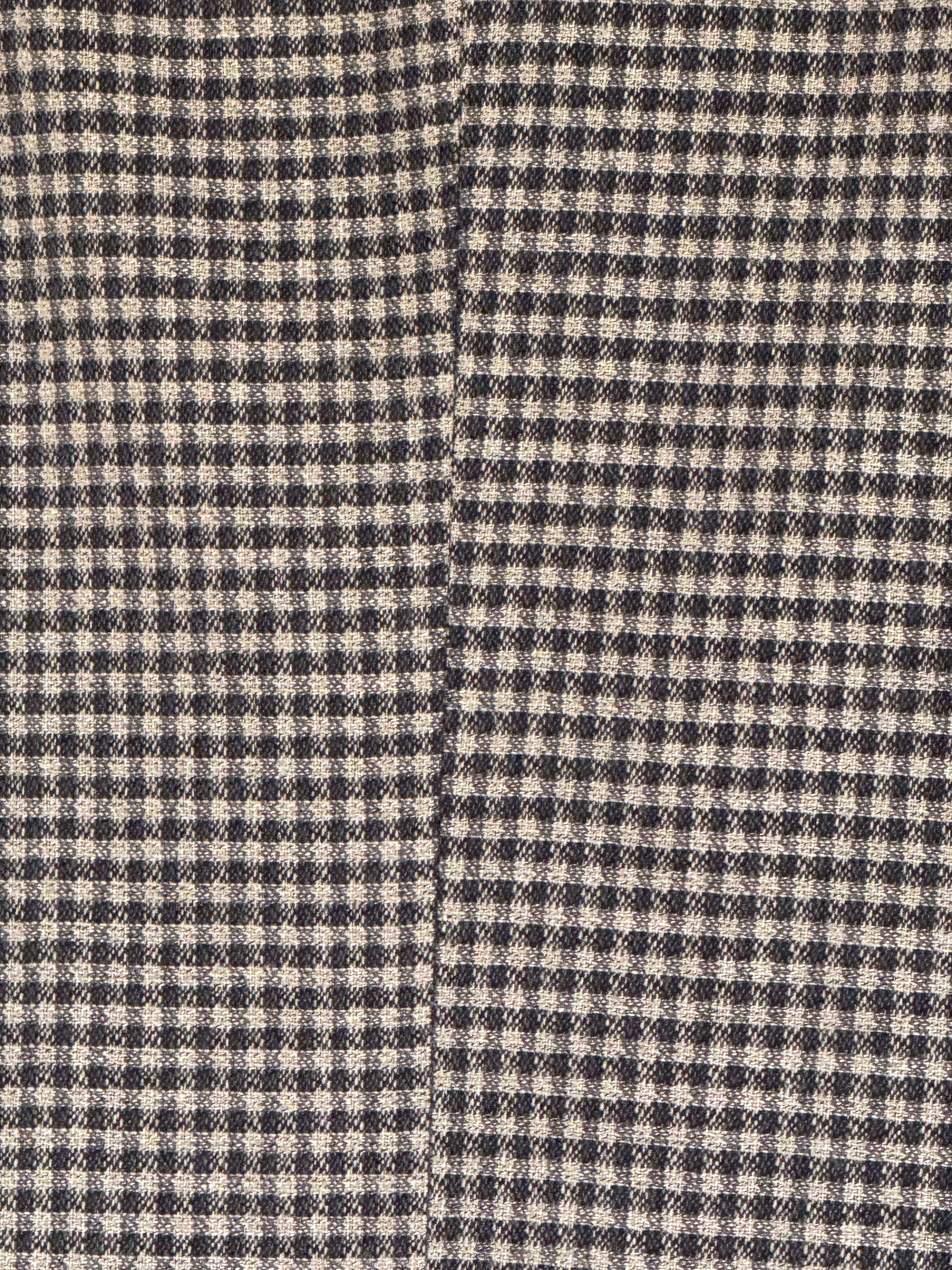 Close-up of the black and cream micro check woven fabric
