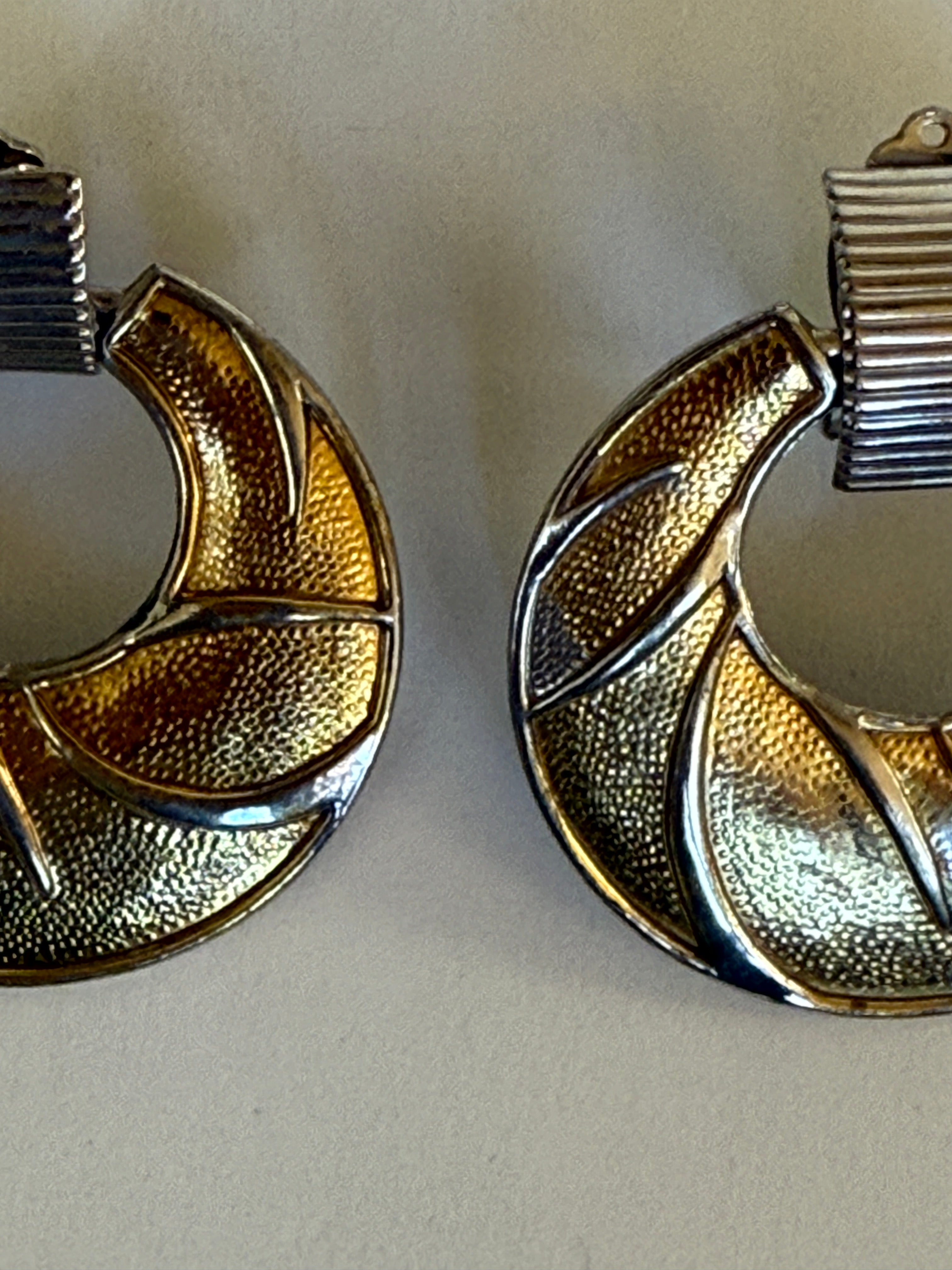 Vintage two-tone gold and silver swirl clip-on earrings textured metal close-up