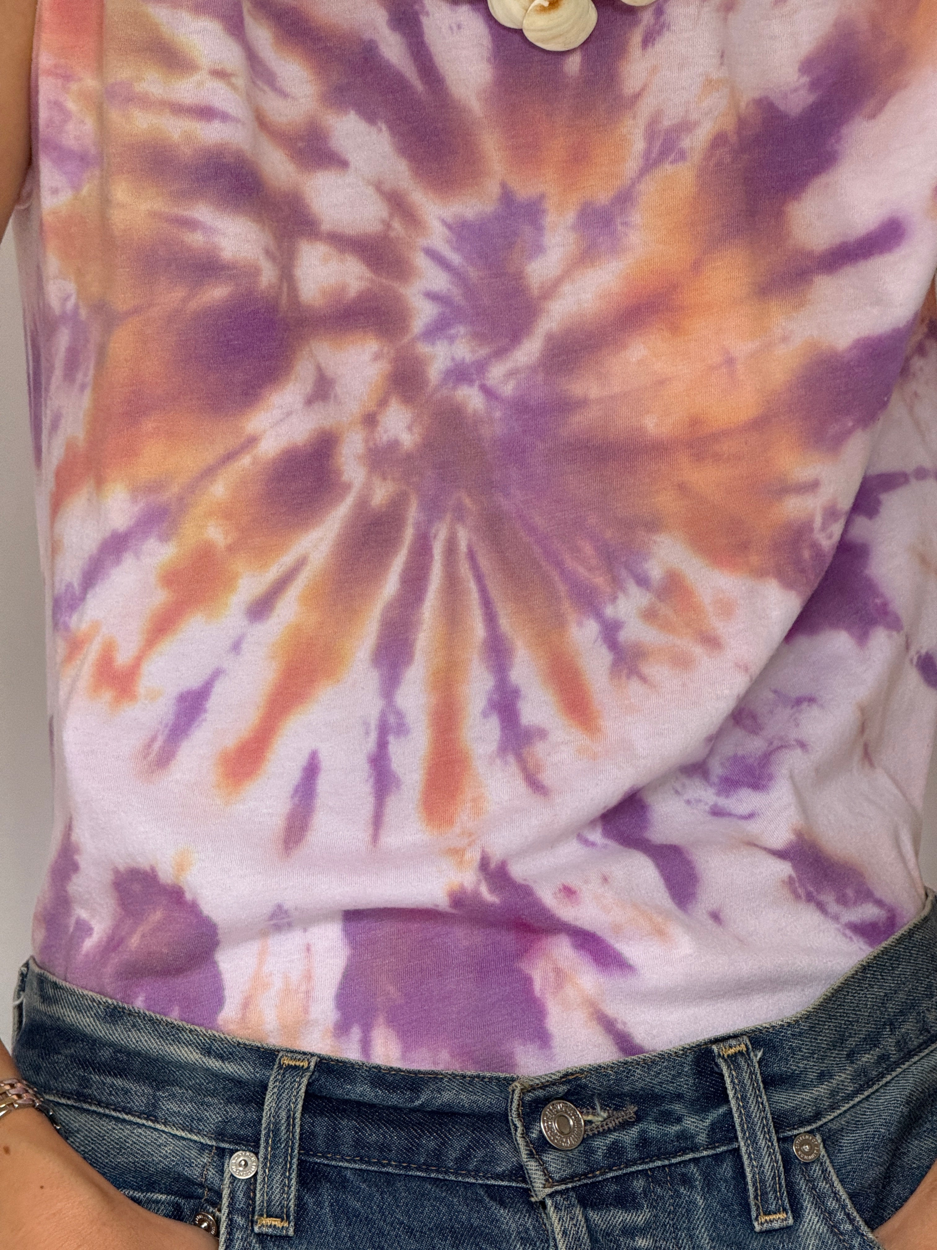 Vintage crewneck tie-dye tee featuring purple peach and white pattern close-up