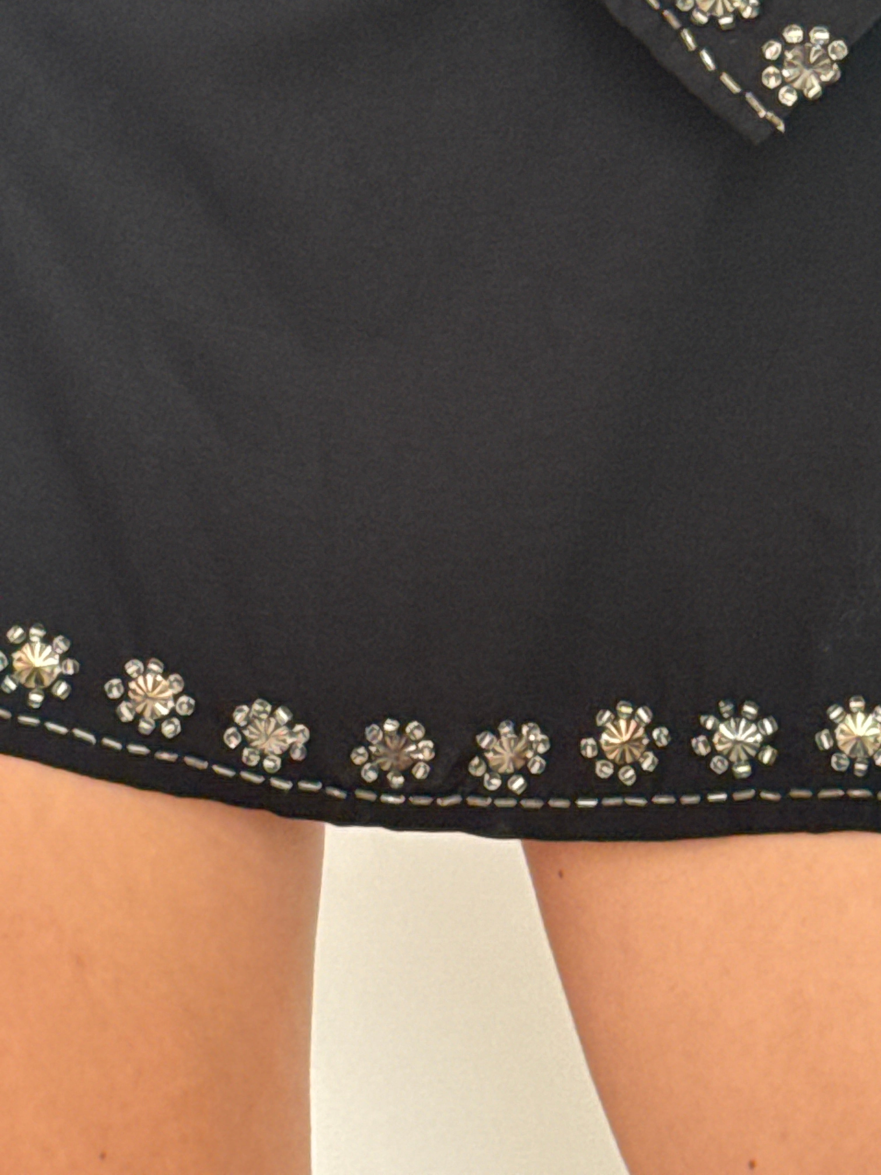 Vintage black tunic dress showcasing silver beadwork along neckline and hem