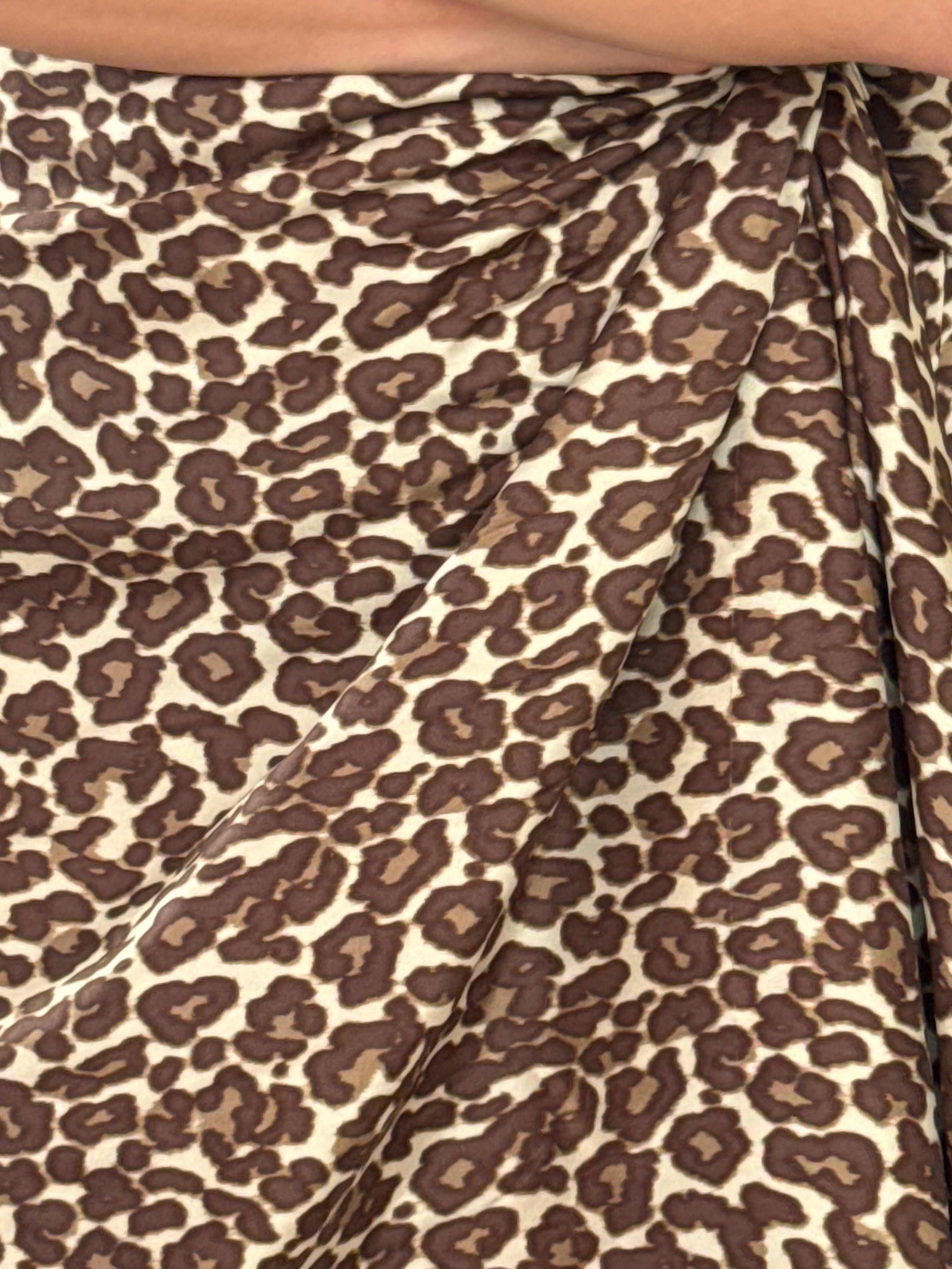 Close-up of leopard print fabric and raw/frayed hem edge