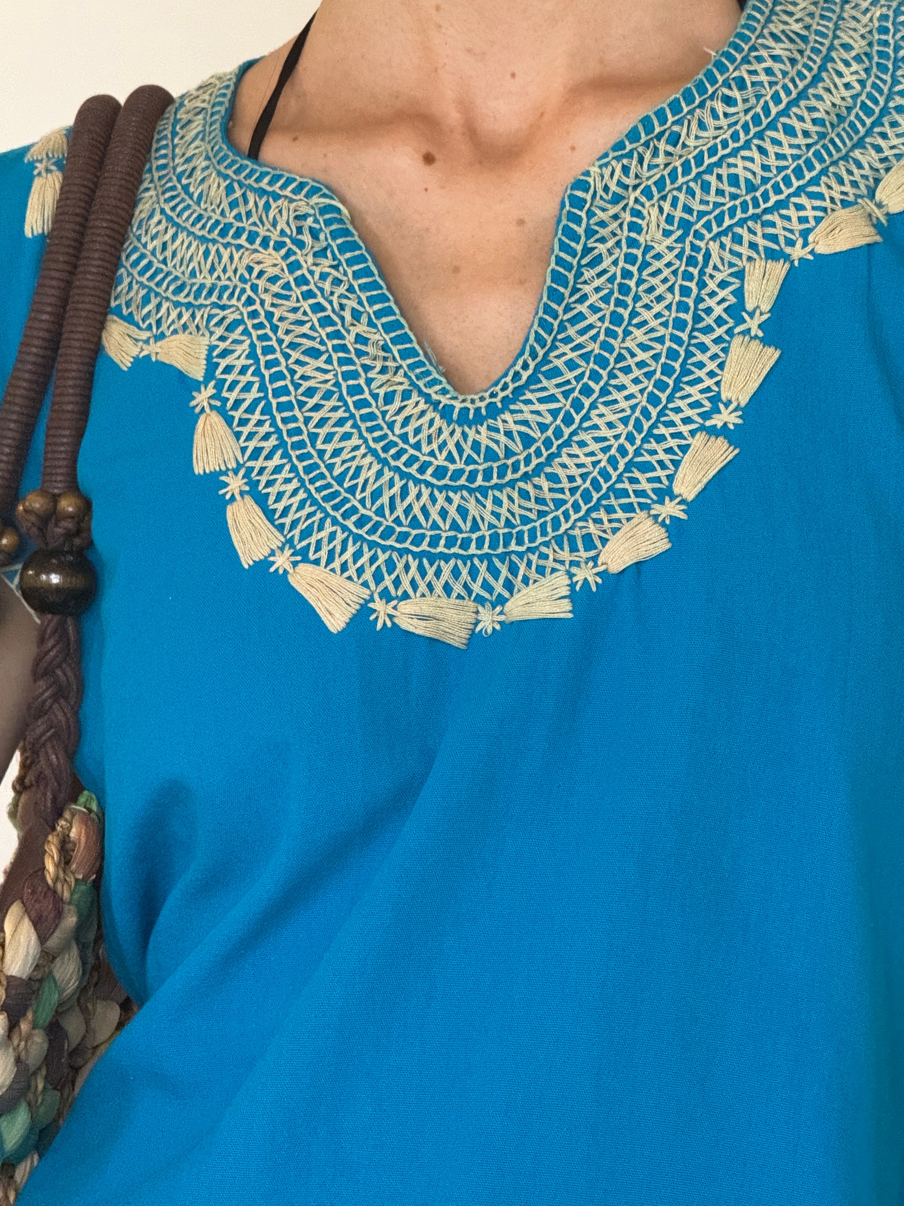 Vintage turquoise embroidered neckline close-up