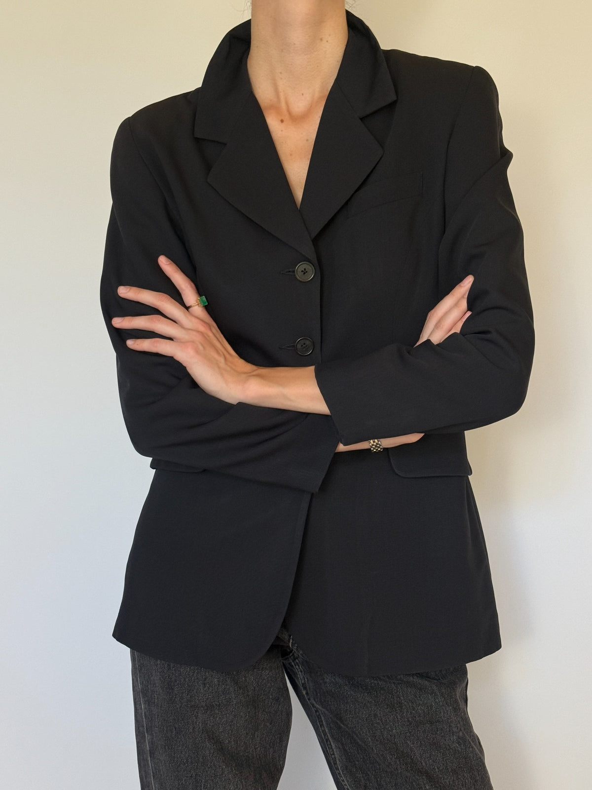 Navy blazer with arms crossed showing sleeves
