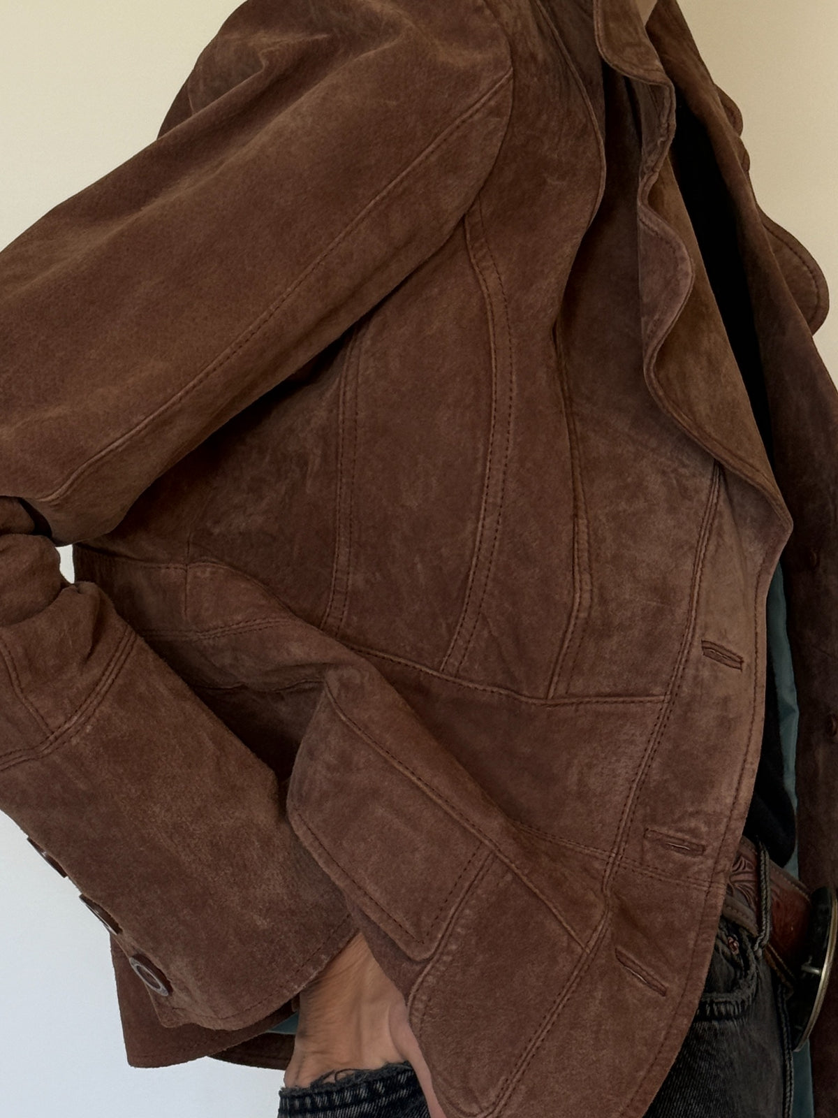 Front flap pockets of vintage brown suede leather jacket