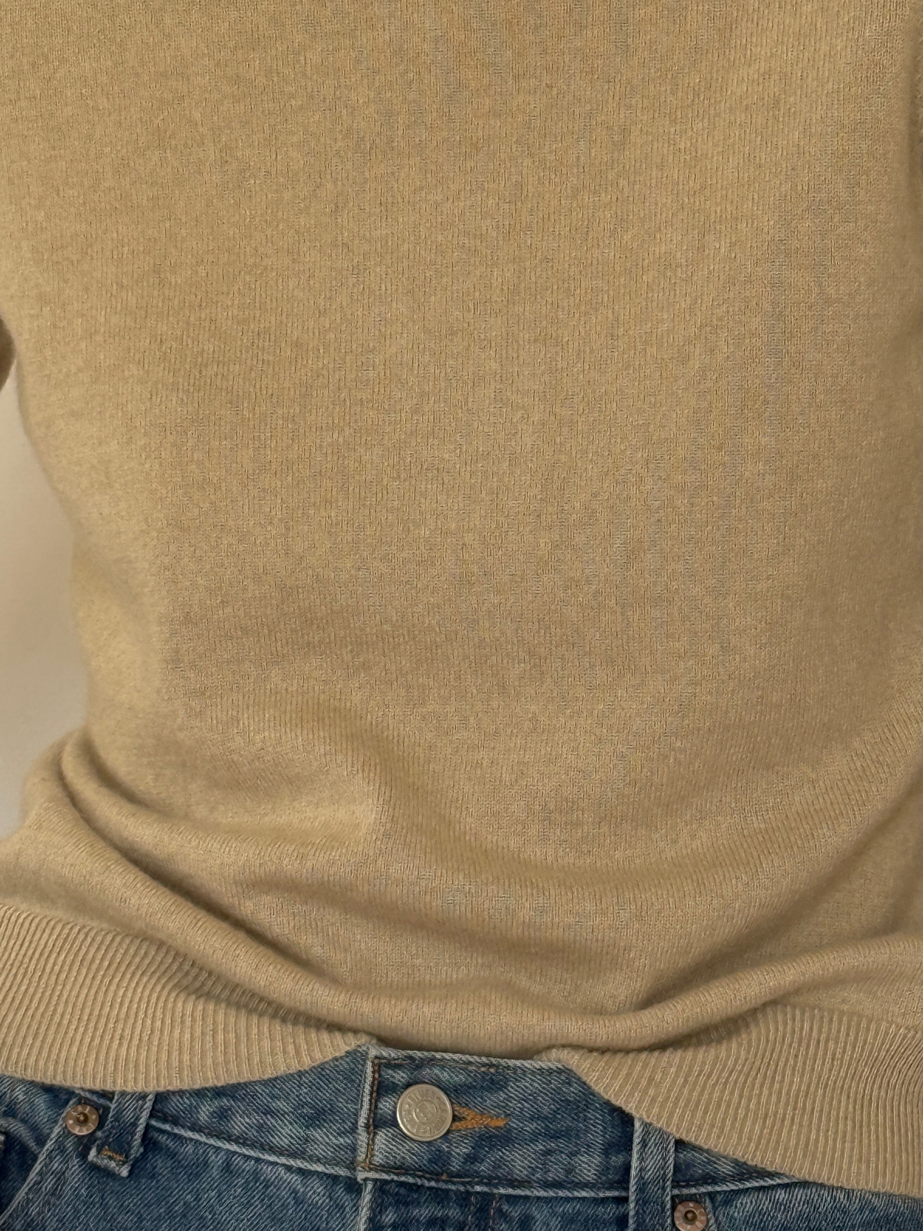 Vintage beige cashmere sweater fabric close-up