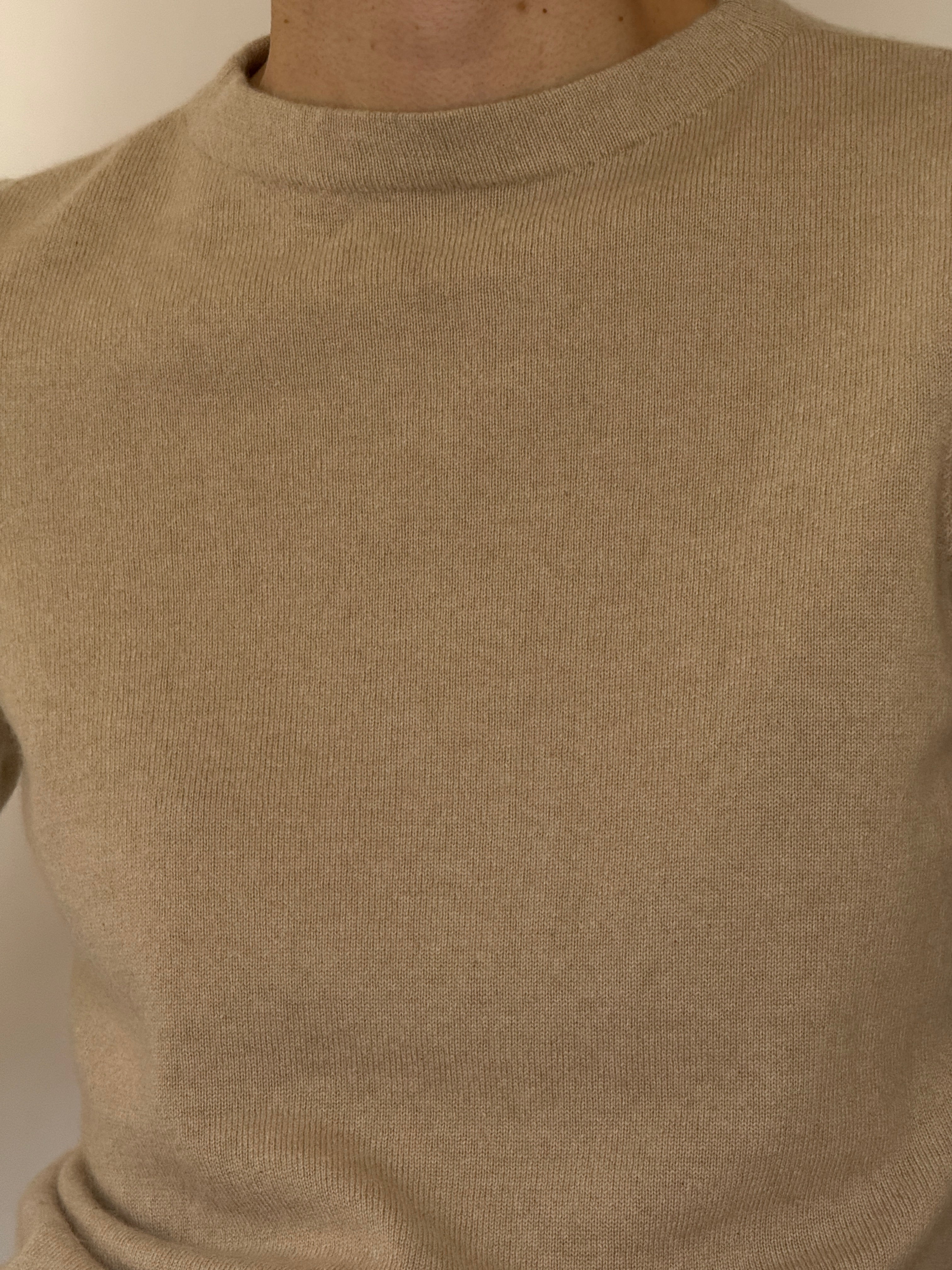Vintage beige cashmere sweater fabric close-up