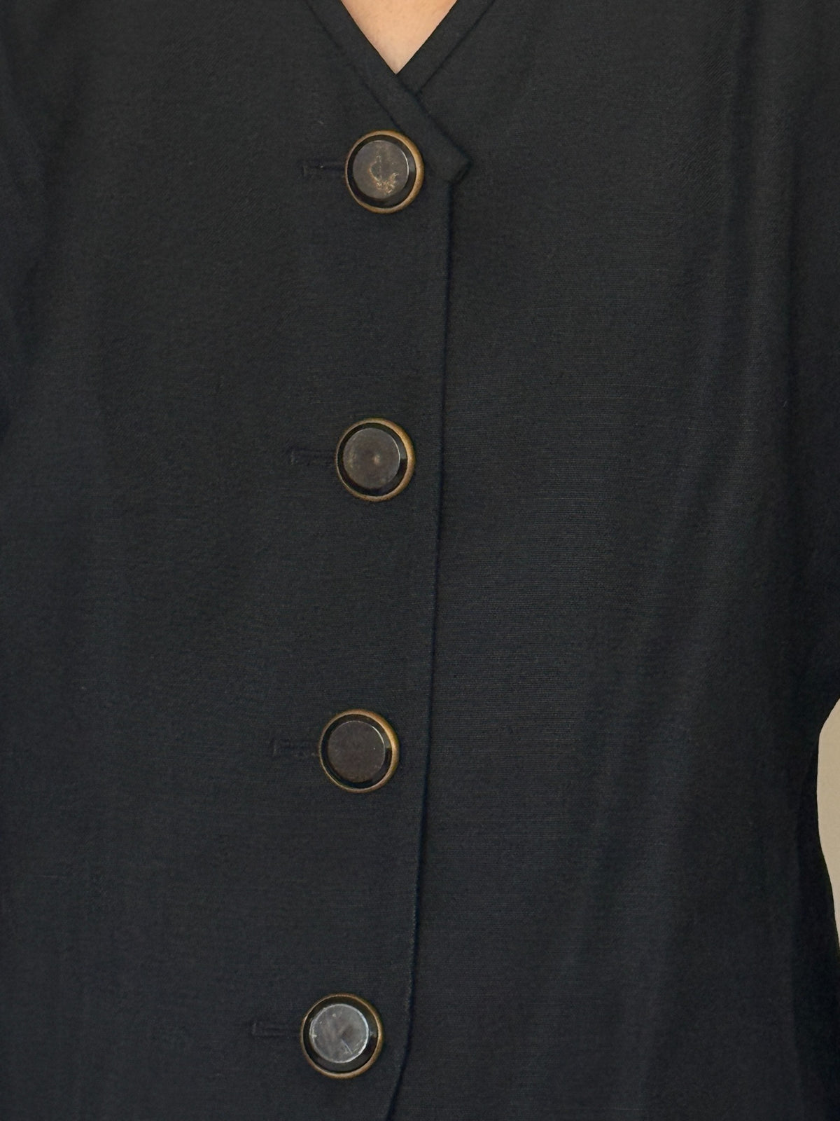 Close-up of V neckline and front buttons