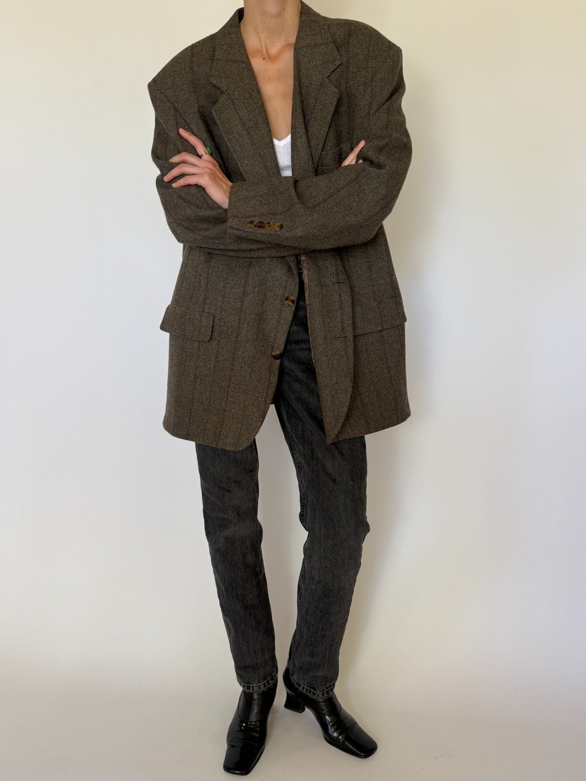 Front crossed arms styling of oversized blazer