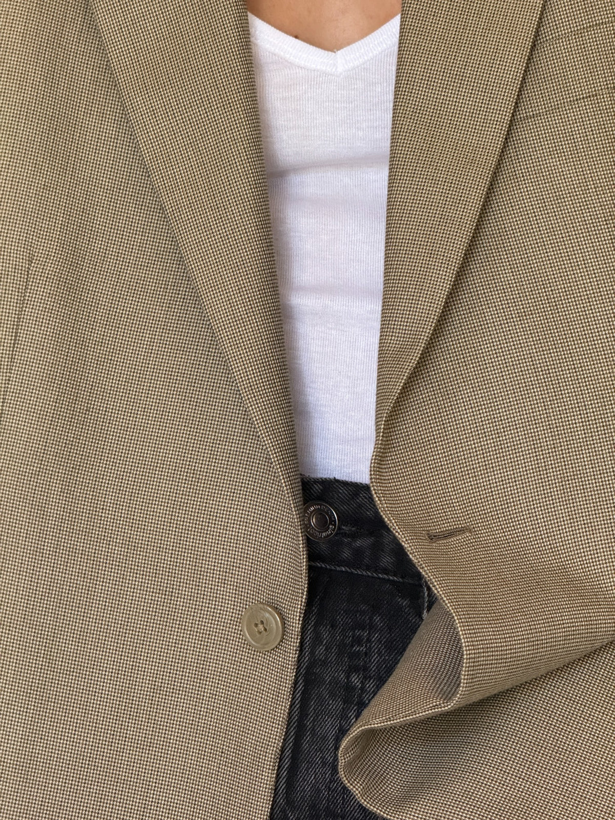 Two button closure detail on beige blazer