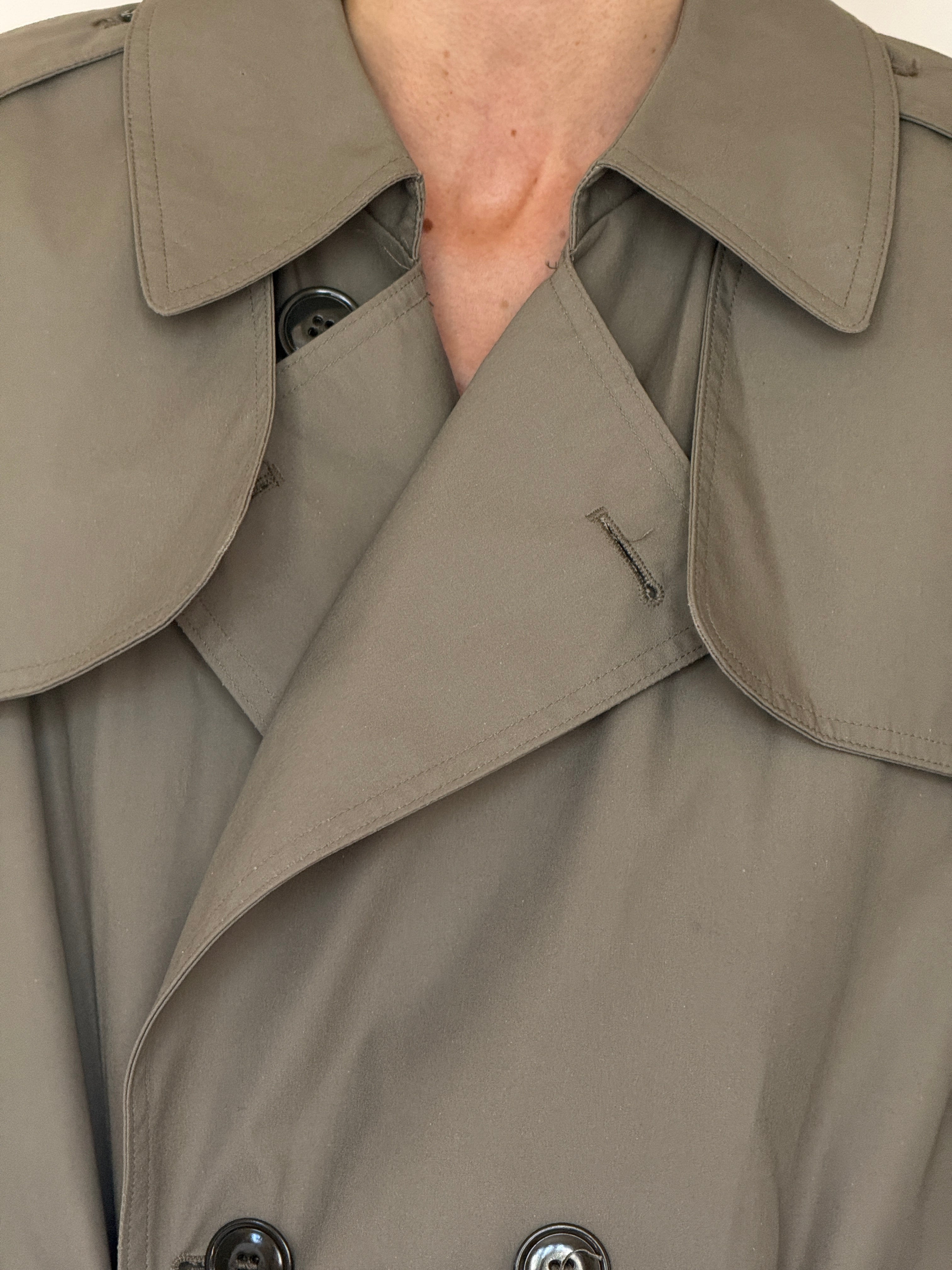 Vintage olive trench coat fabric close-up smooth cotton feel