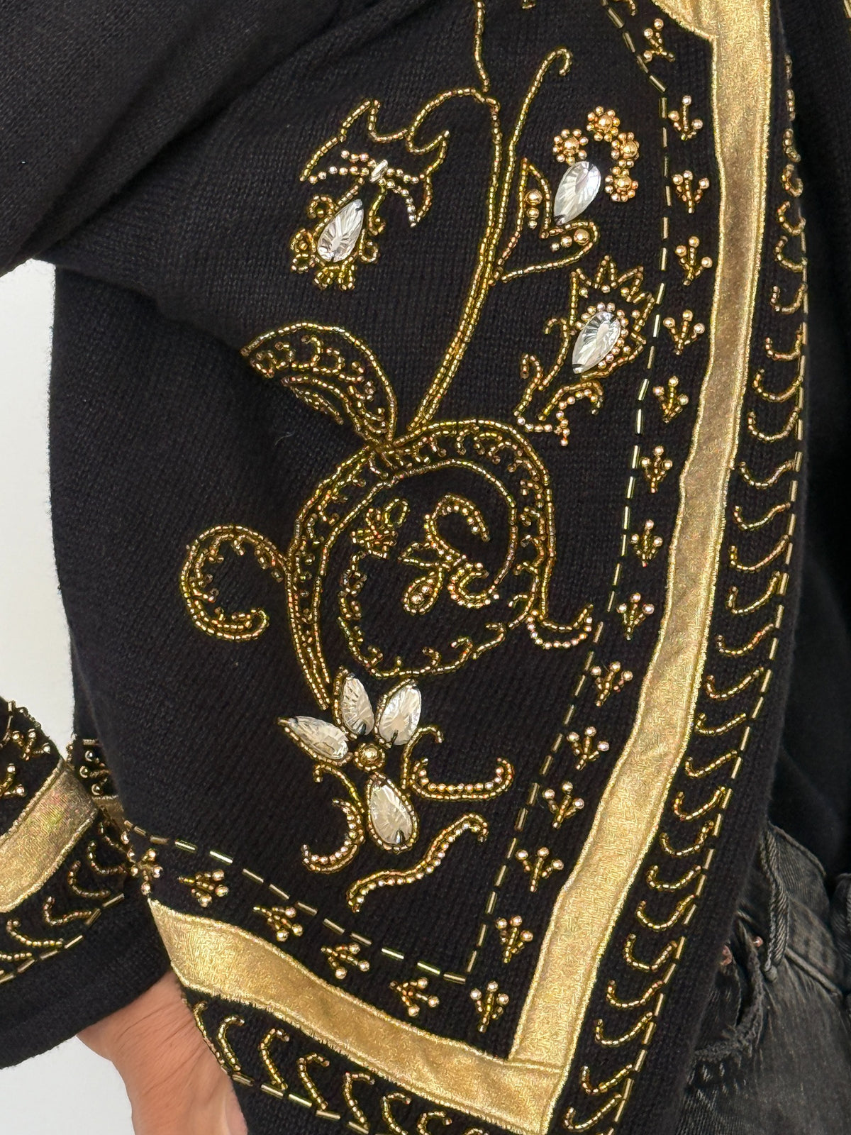 Side profile of black and gold vintage cardigan
