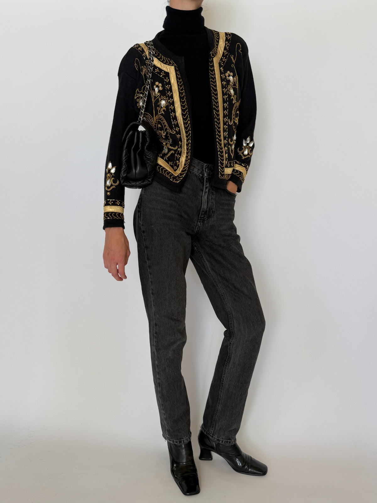 Black cardigan styled with dark denim and shoulder bag