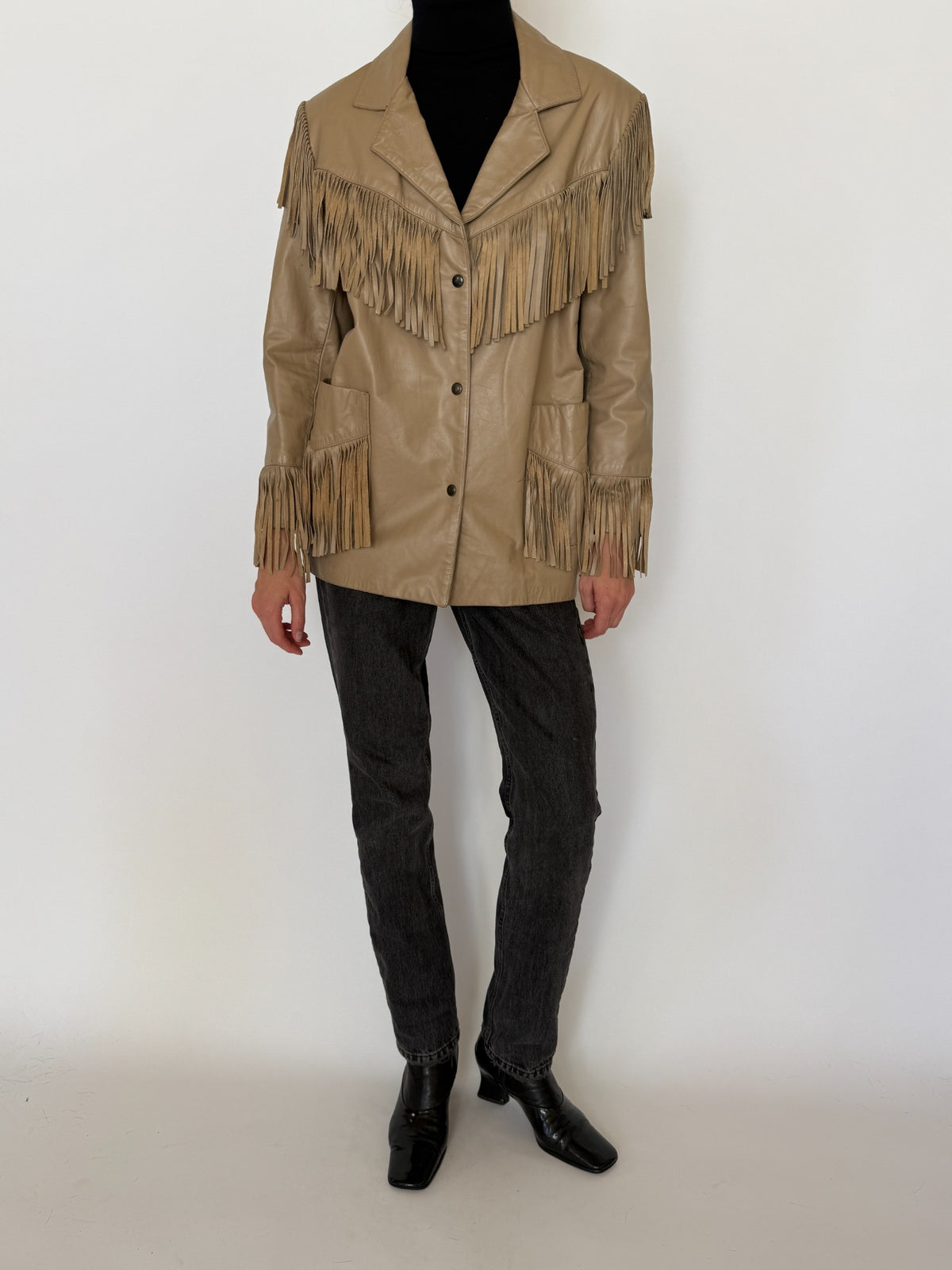 Front view of vintage tan Western fringe leather jacket