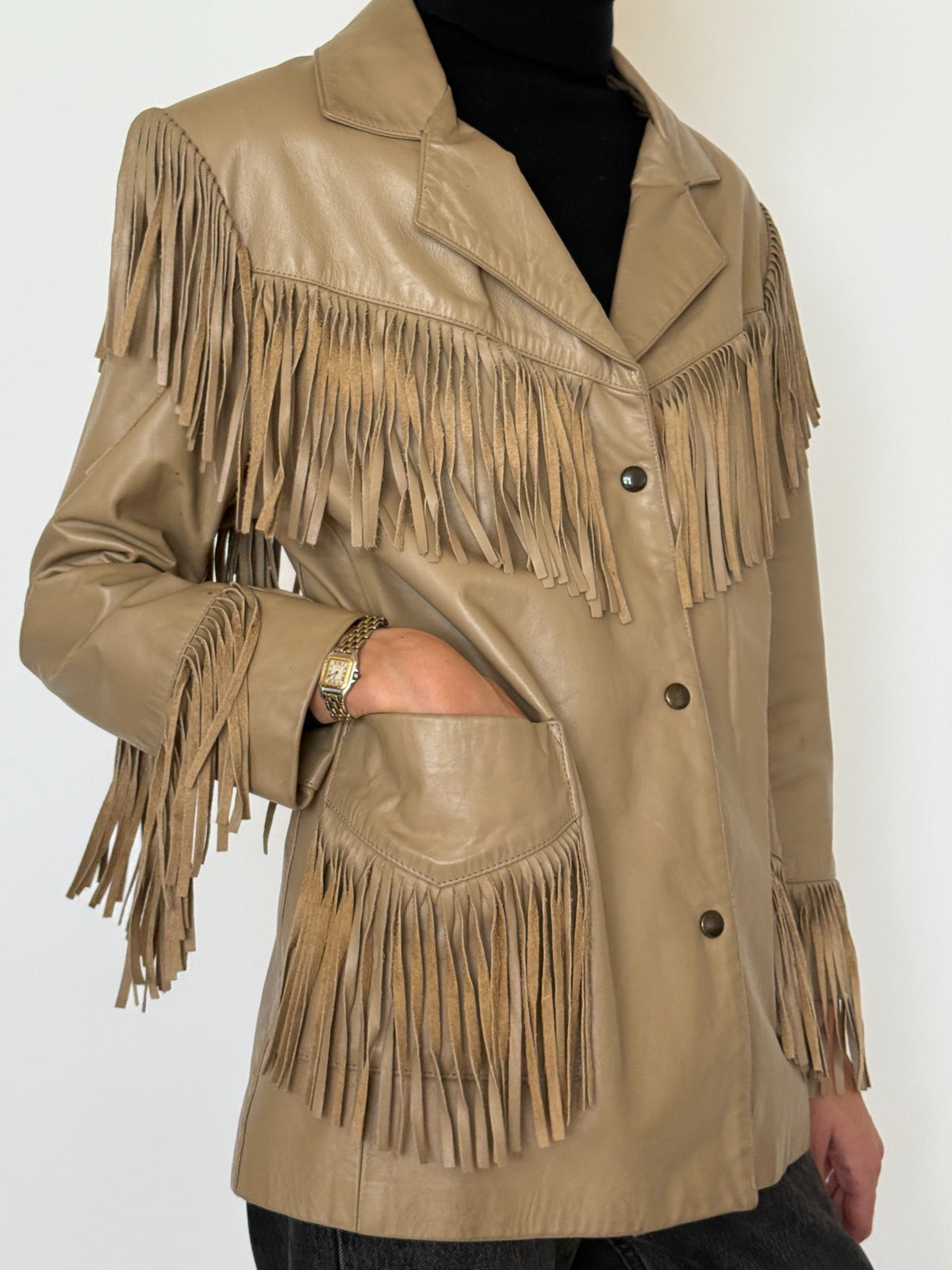 Front styled view of tan leather fringe jacket