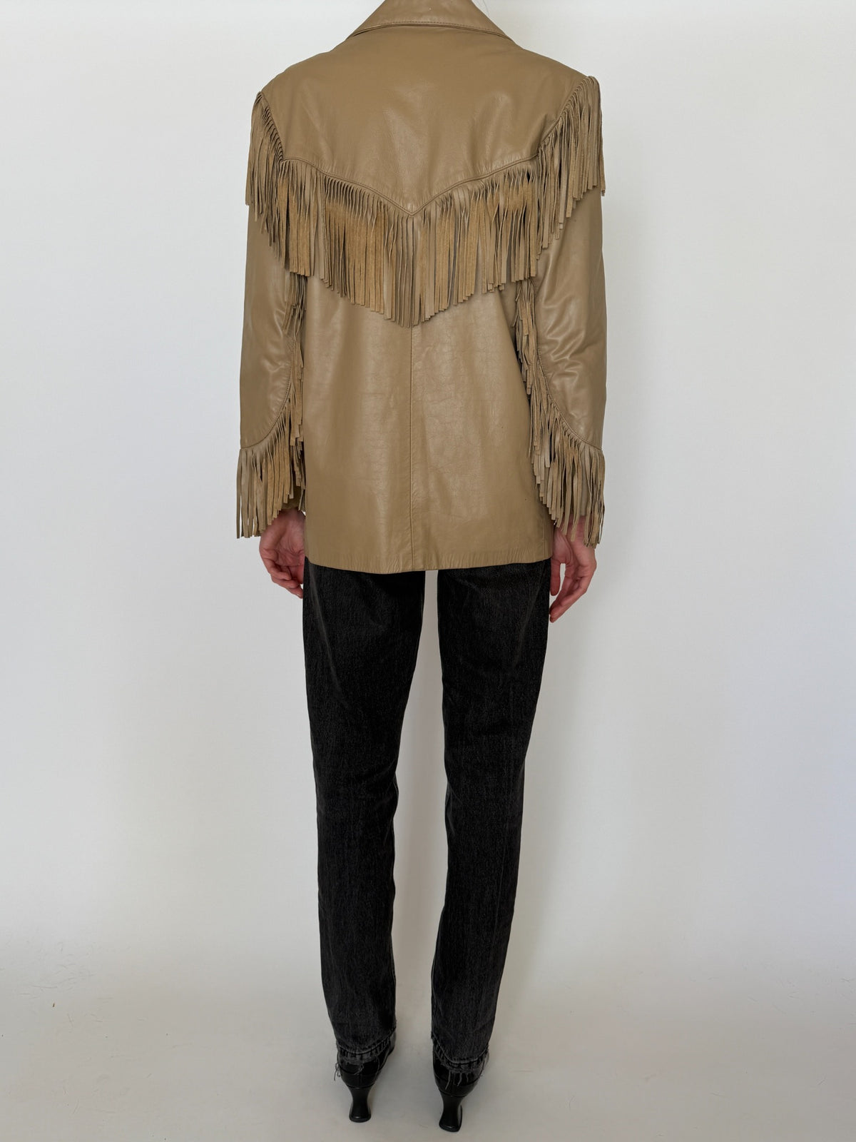 Back view of vintage tan Western fringe leather jacket