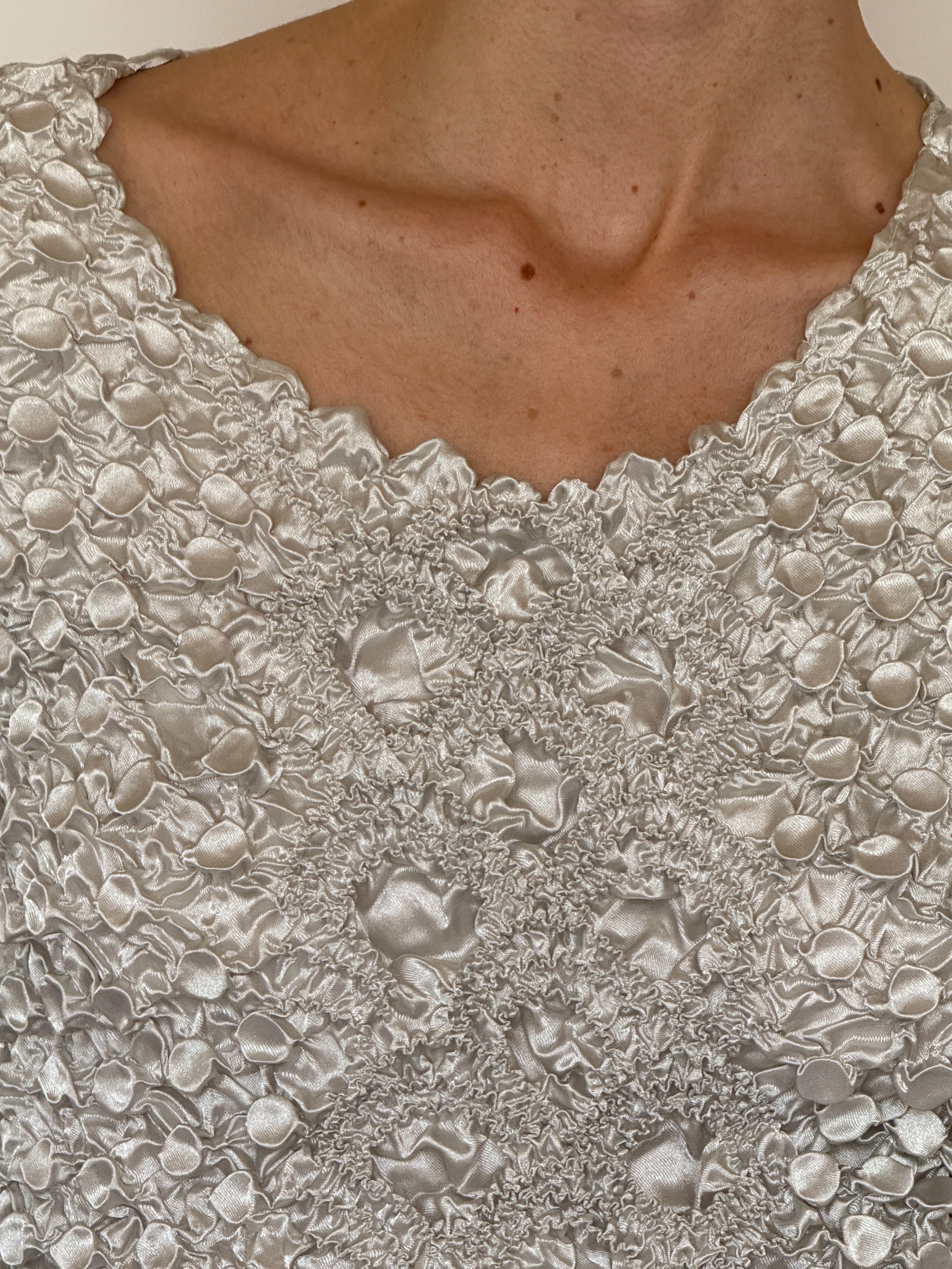 Vintage ivory faded silver popcorn fabric close-up