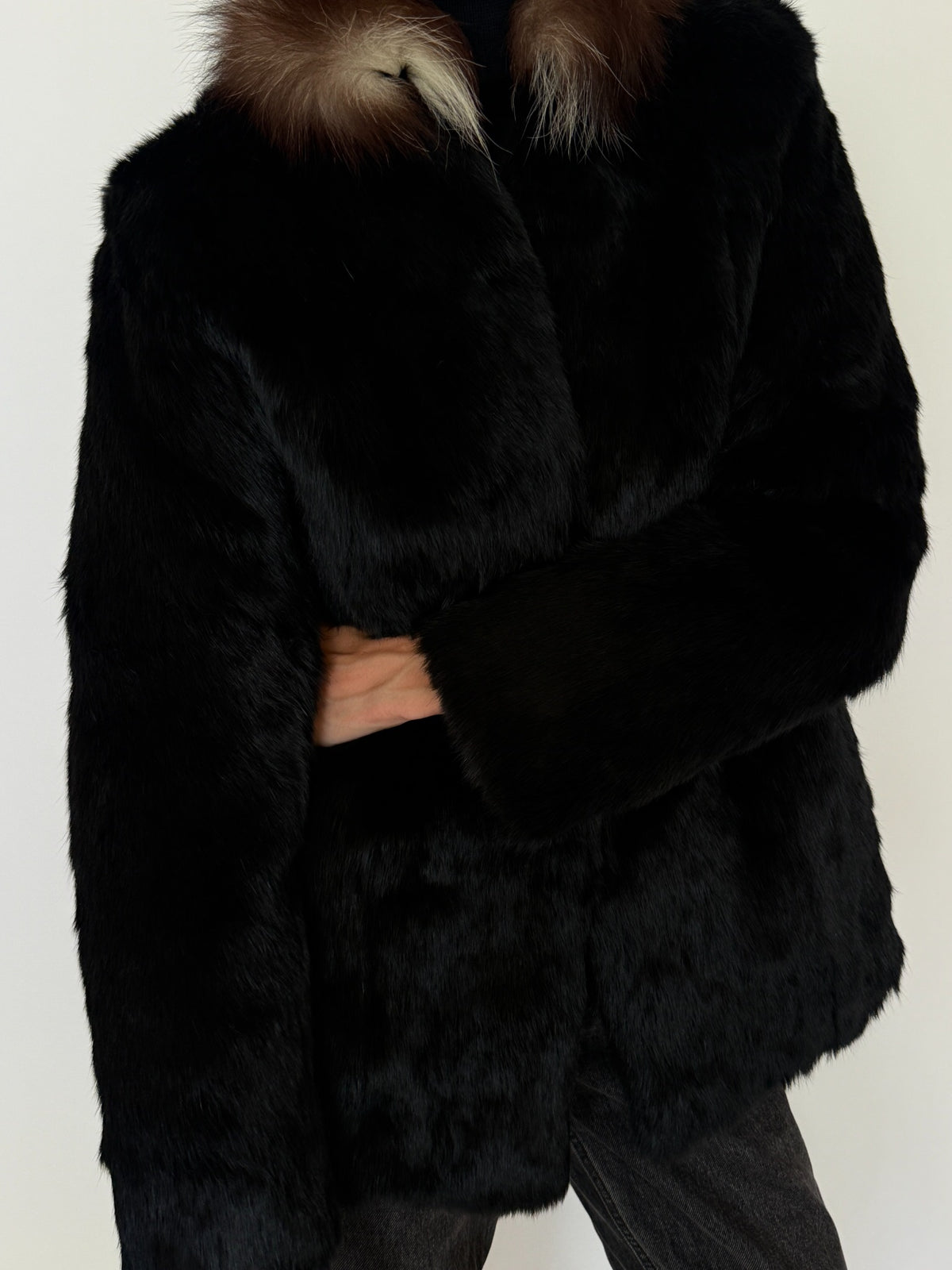 Full-length styled view of black rabbit fur jacket