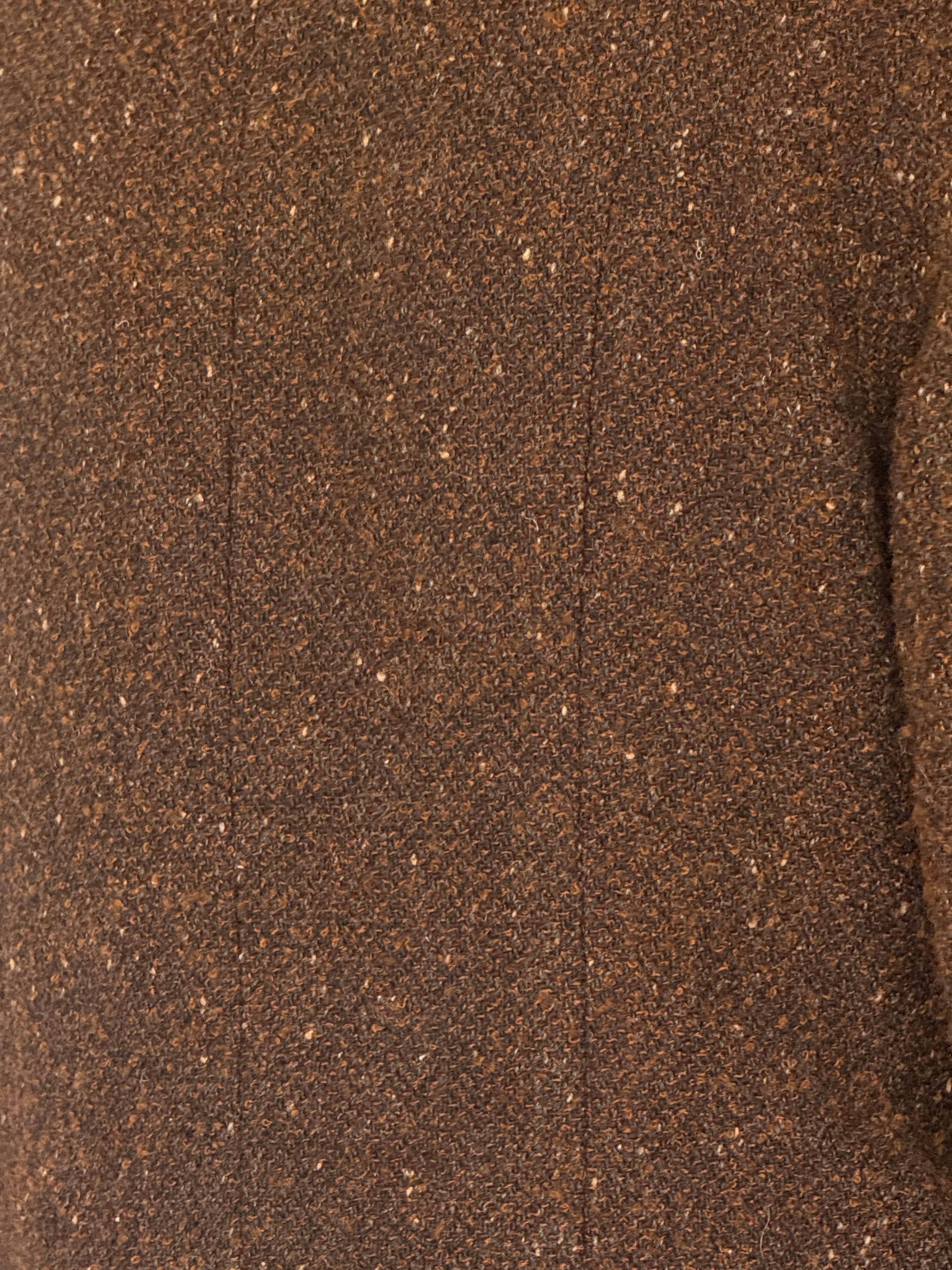 Vintage brown tweed jacket fabric close-up textured wool
