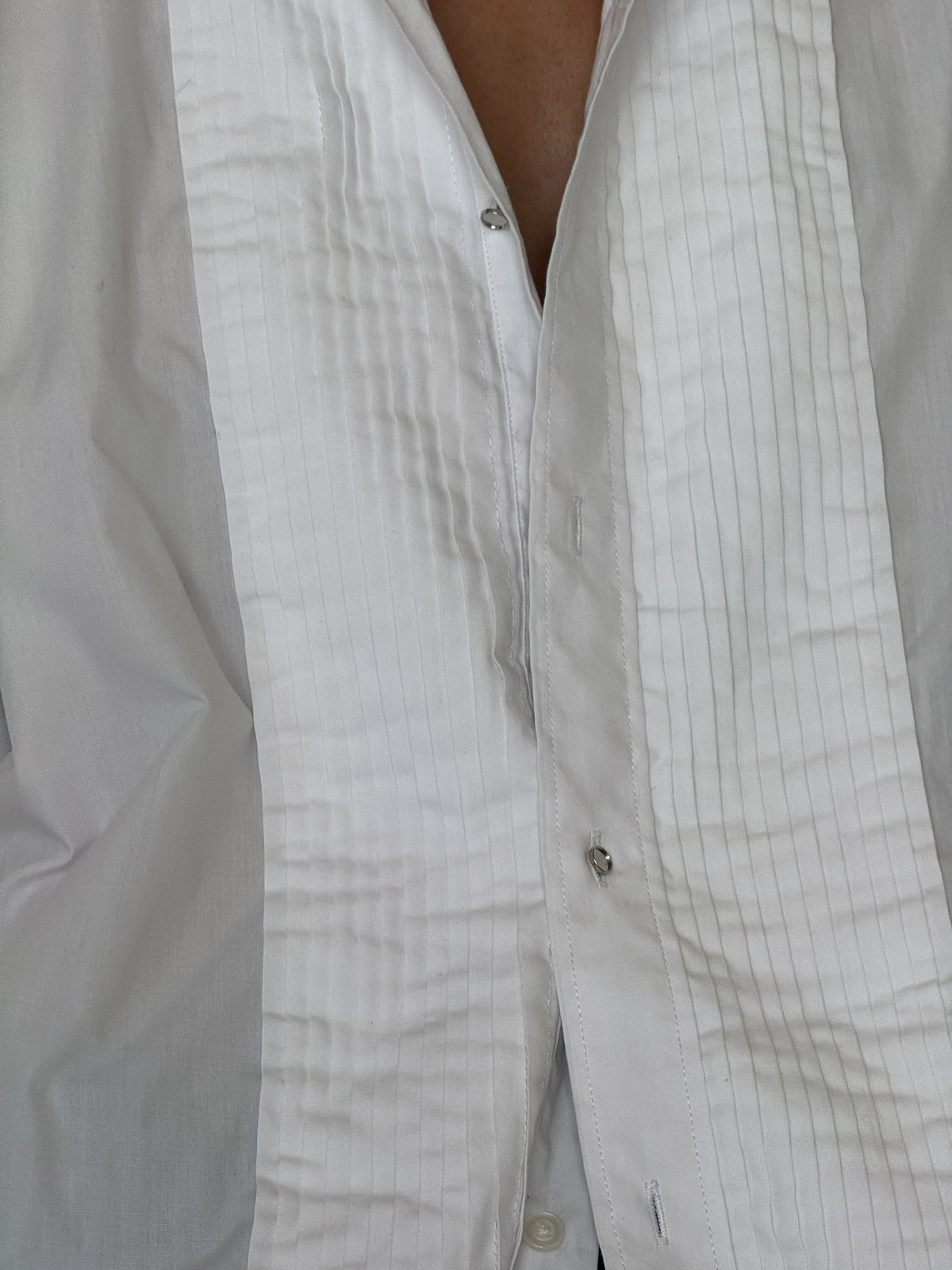 Close up of pintuck bib and button details