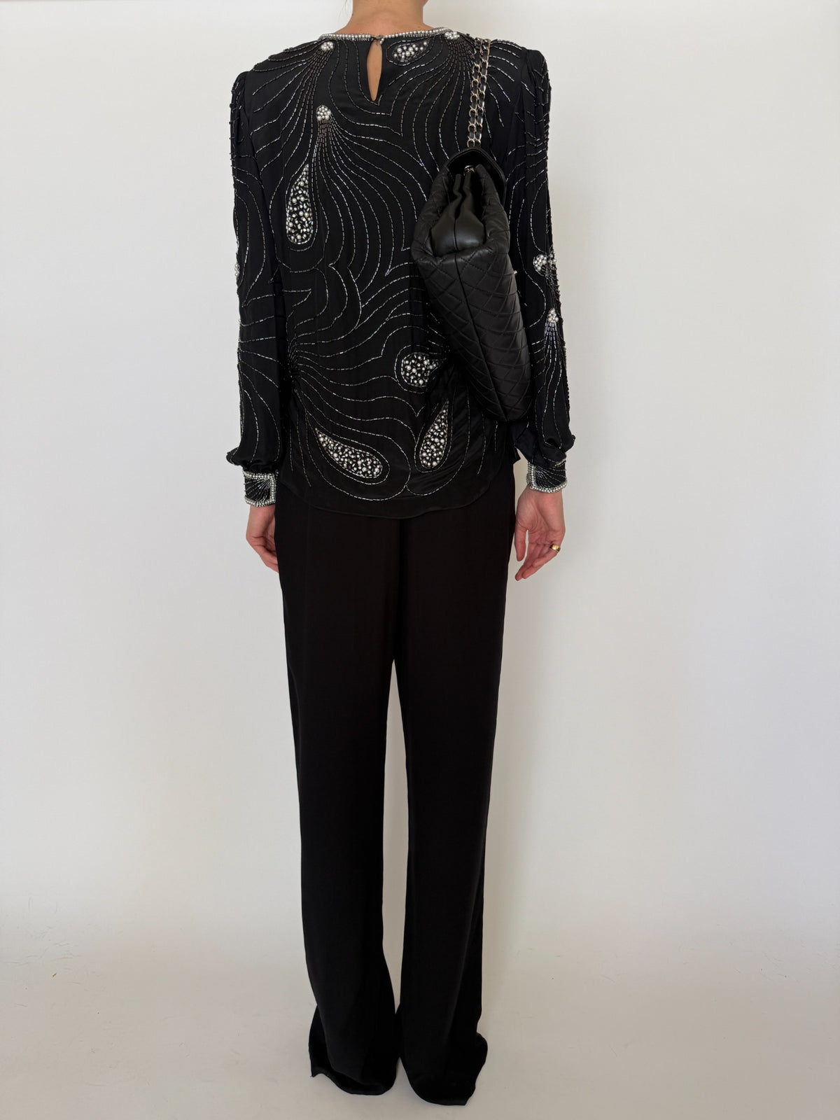 Back view of black beaded silk blouse