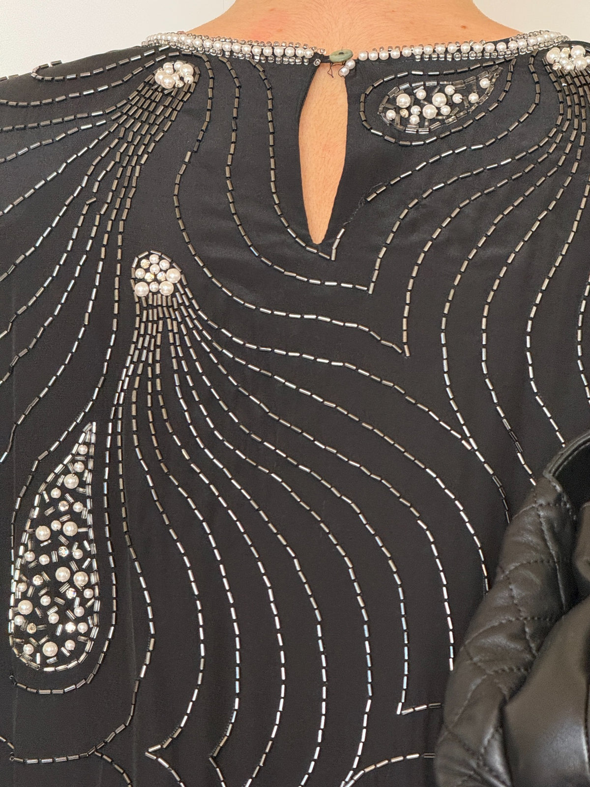 Pearl trim at round neckline