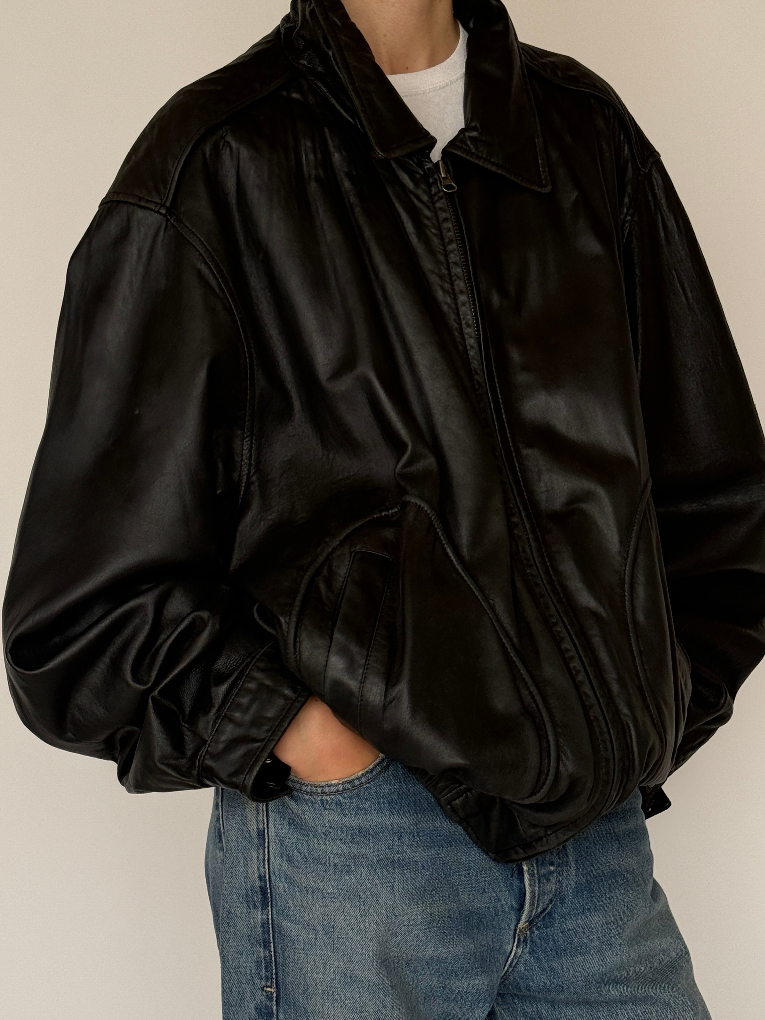 Vintage black leather bomber jacket leather texture close-up