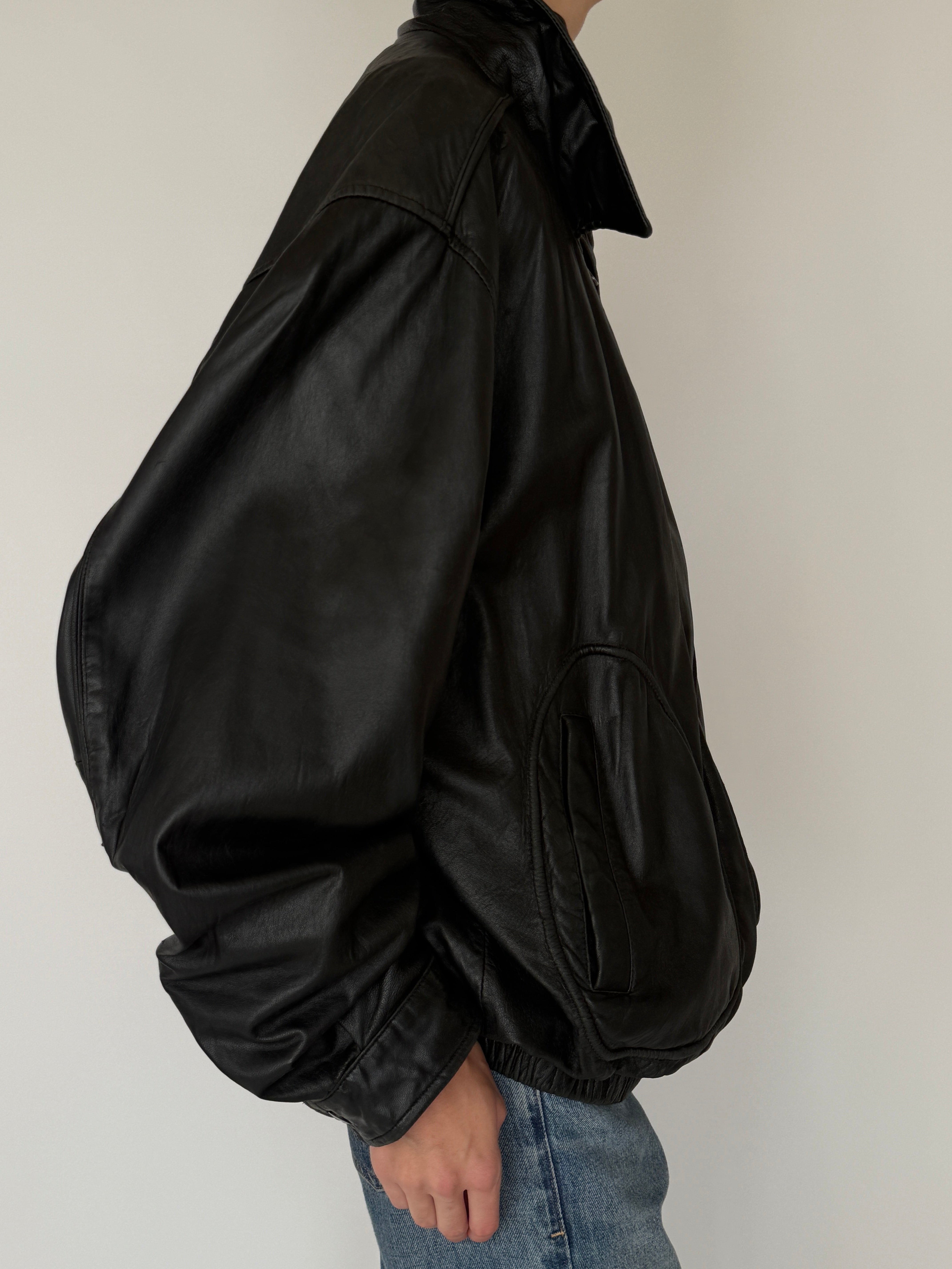 Vintage black leather bomber jacket side view drop shoulder shape