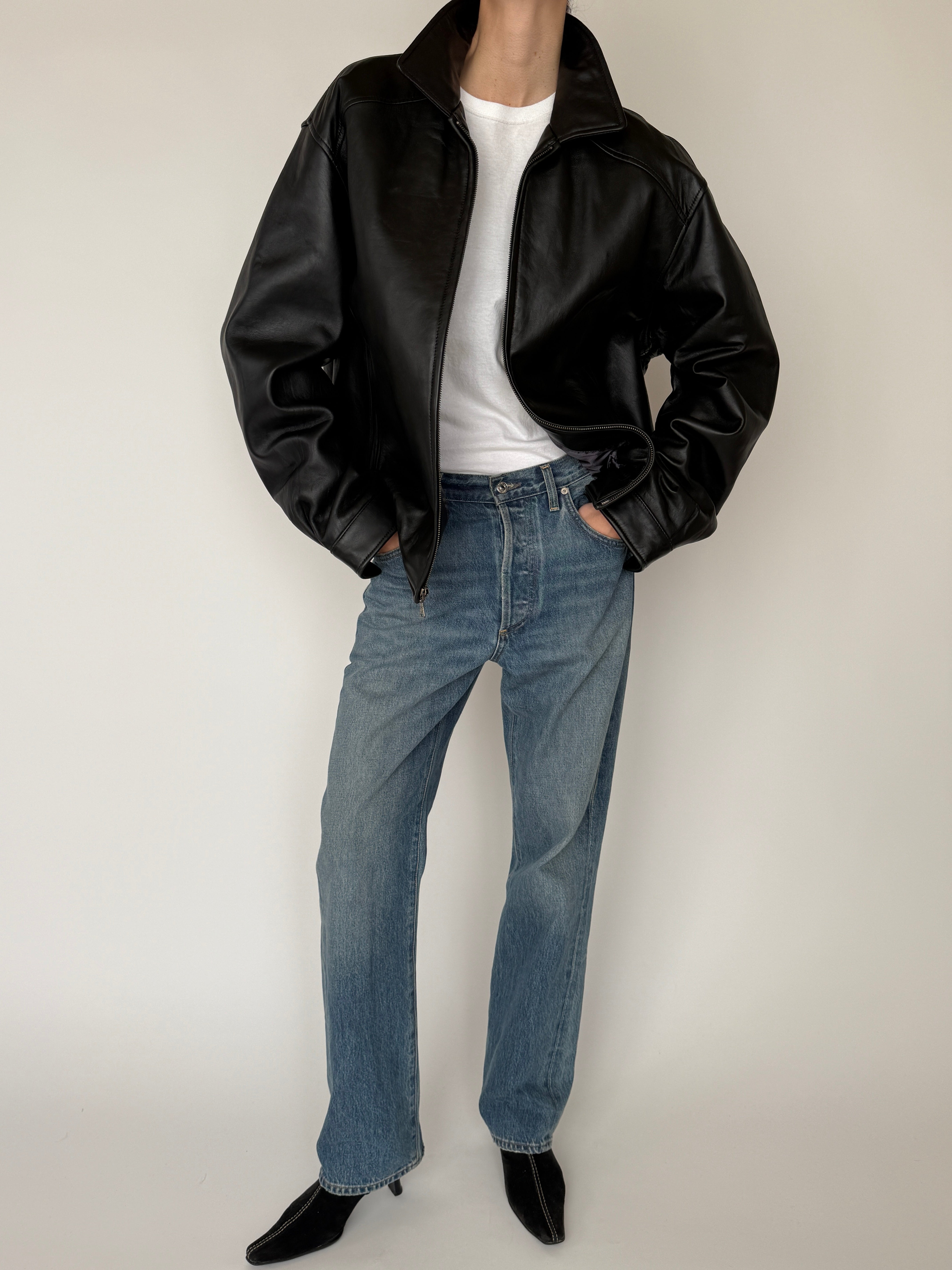Vintage black leather jacket cuff button detail