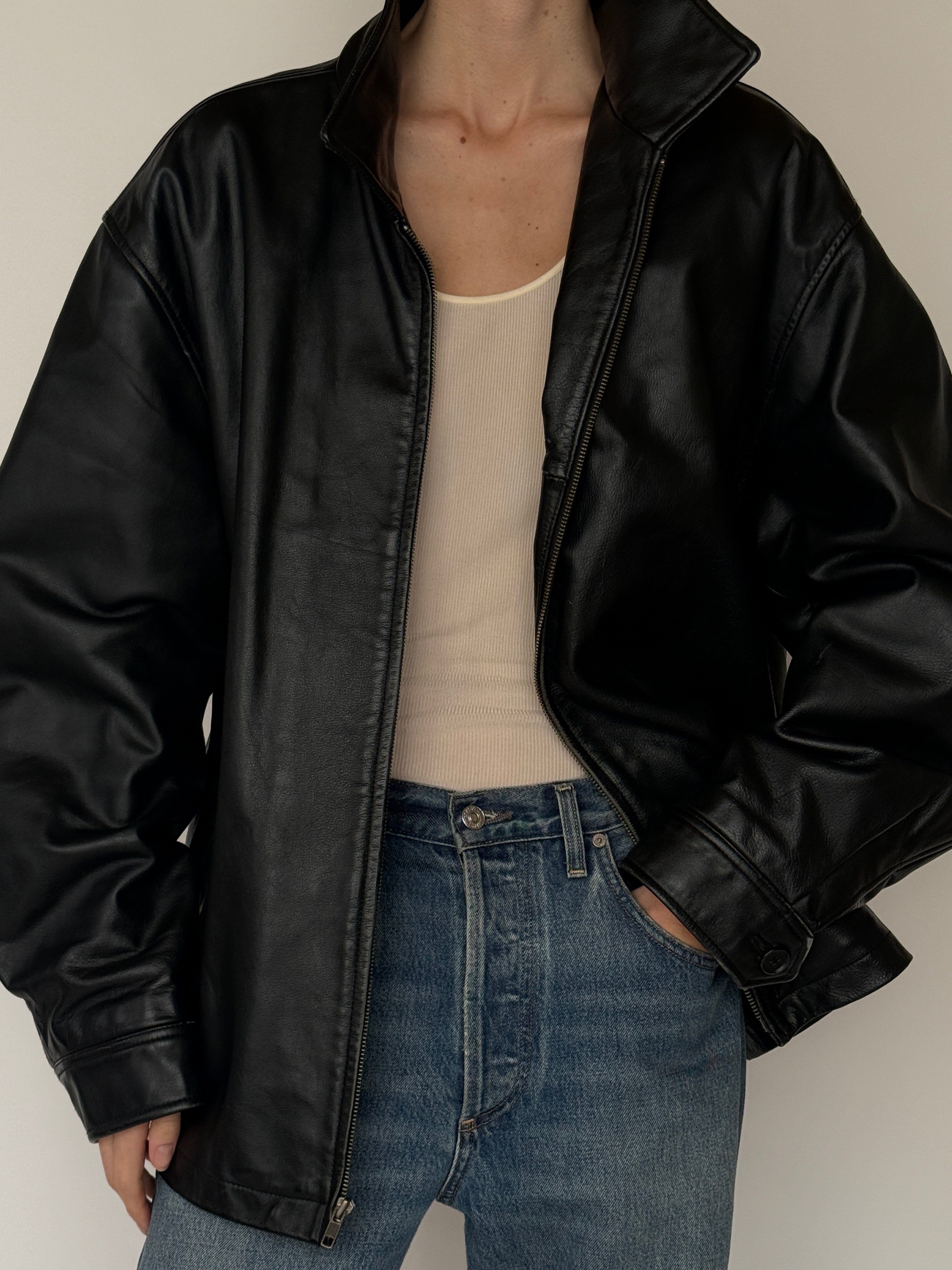 Vintage leather jacket with full-length zipper and soft leather texture in black