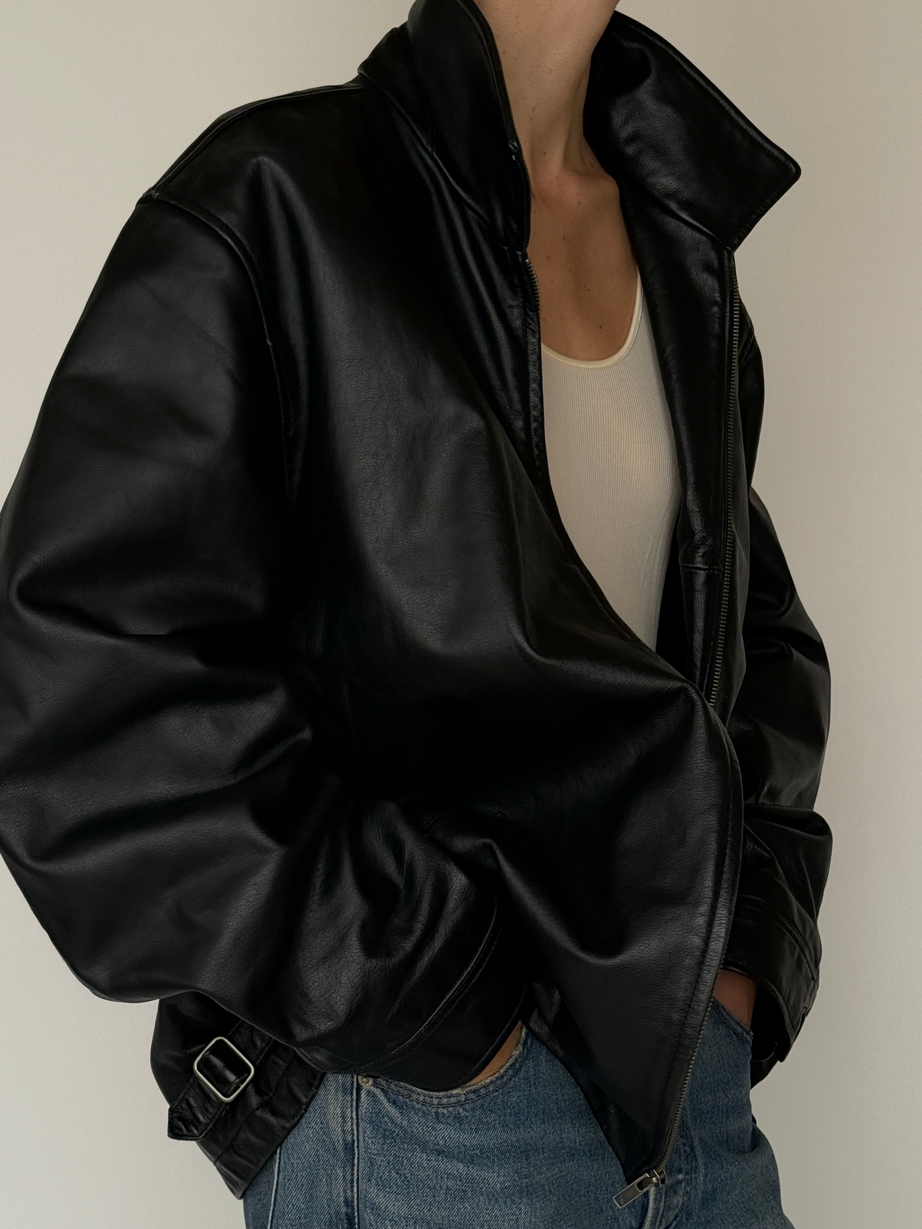 Vintage black leather jacket with zip-front closure and high collar