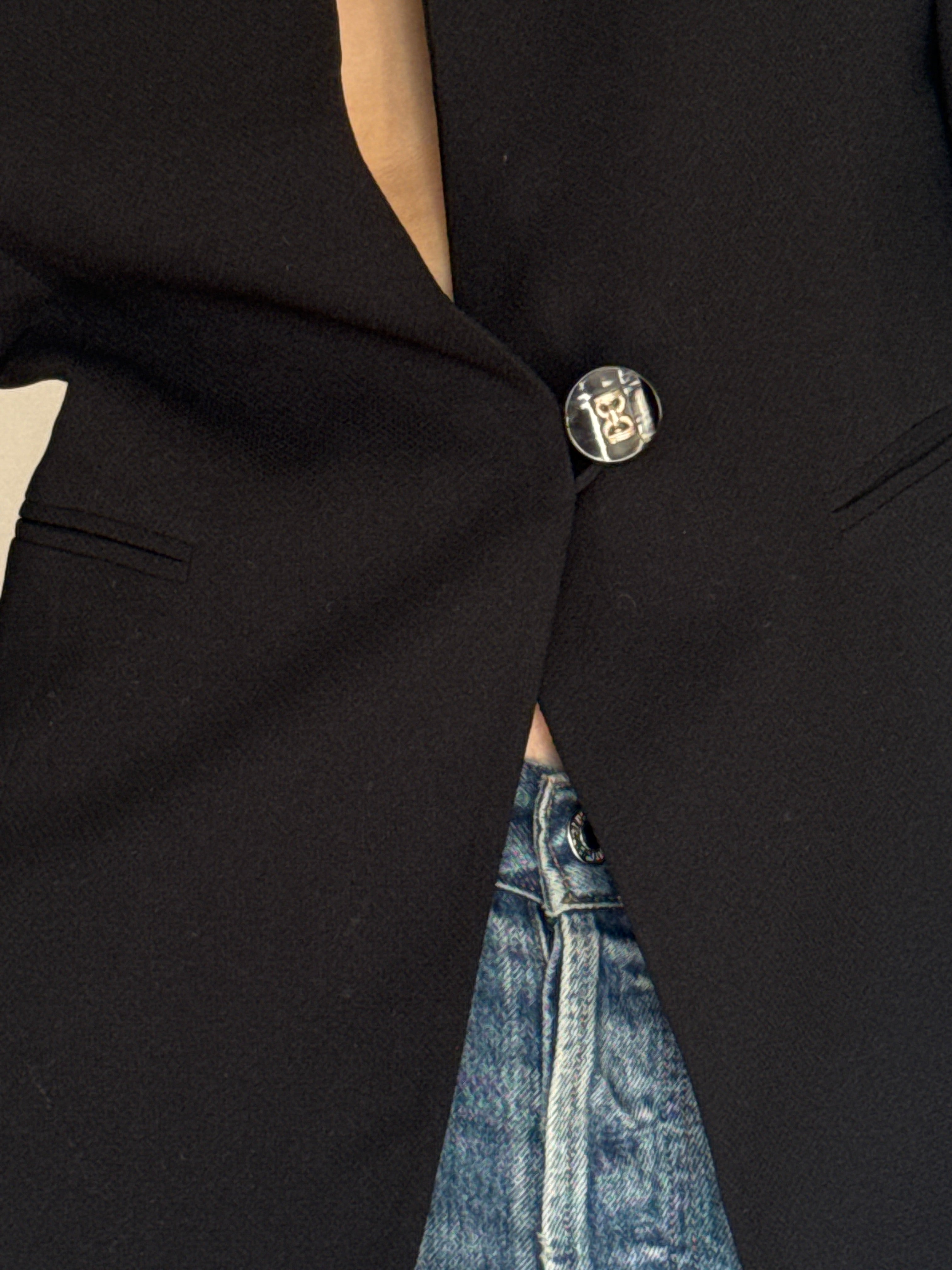 Vintage black blazer statement button detail close-up