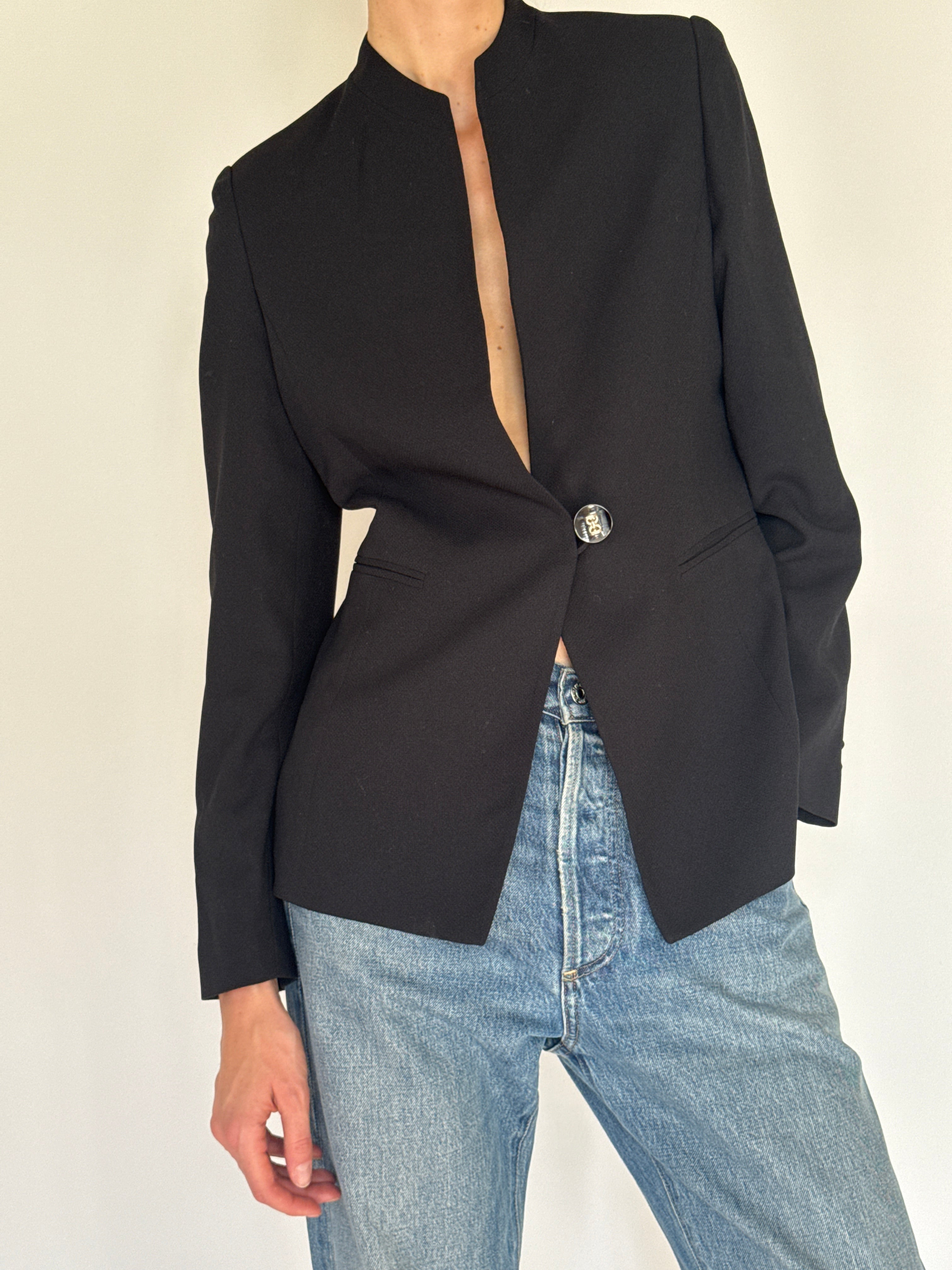 Vintage black blazer statement button detail close-up