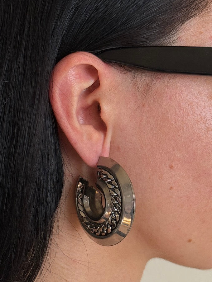 Crescent-shaped hoop earring with a polished silver-tone finish earring