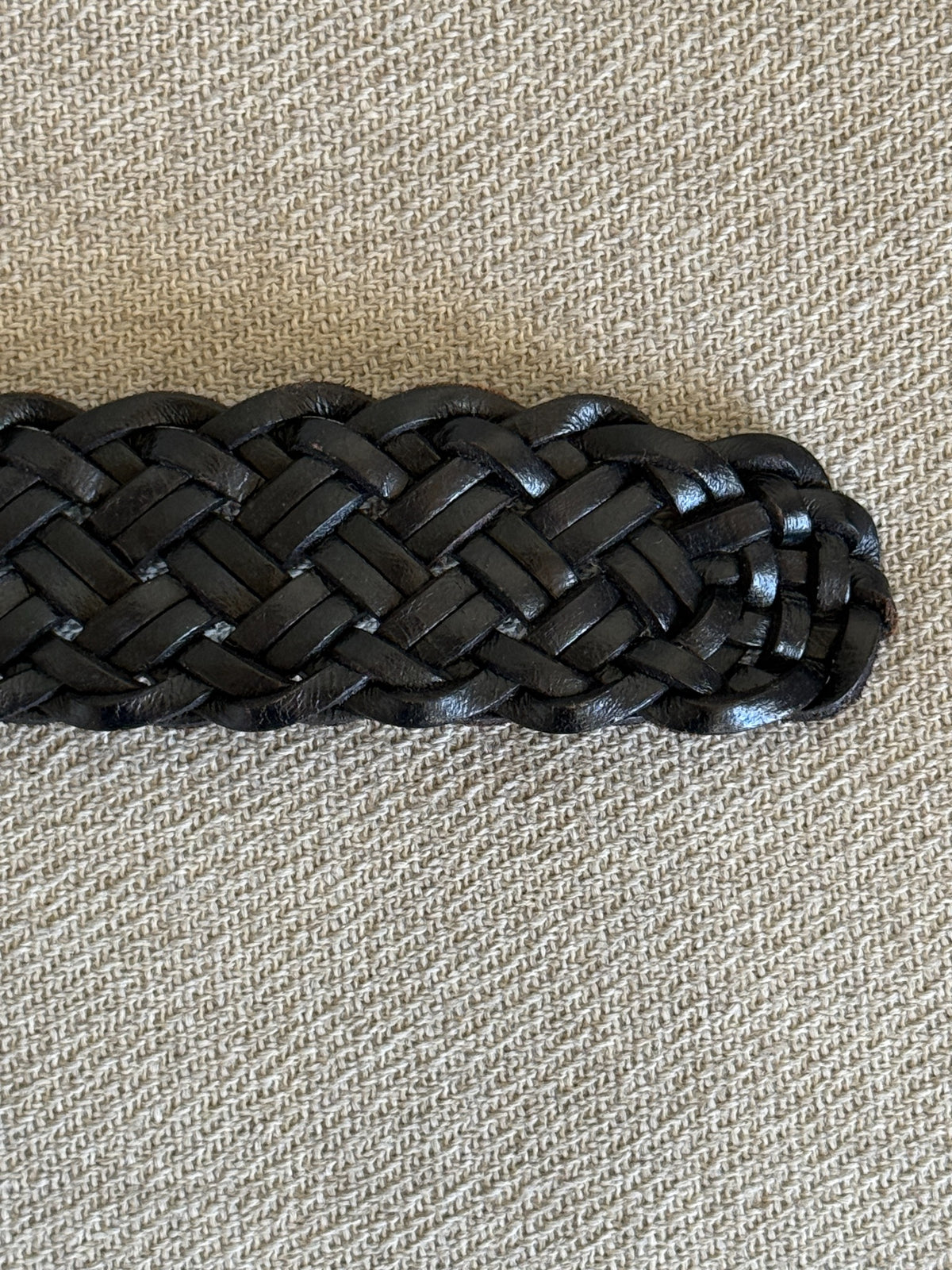 Detail of black braided leather belt texture