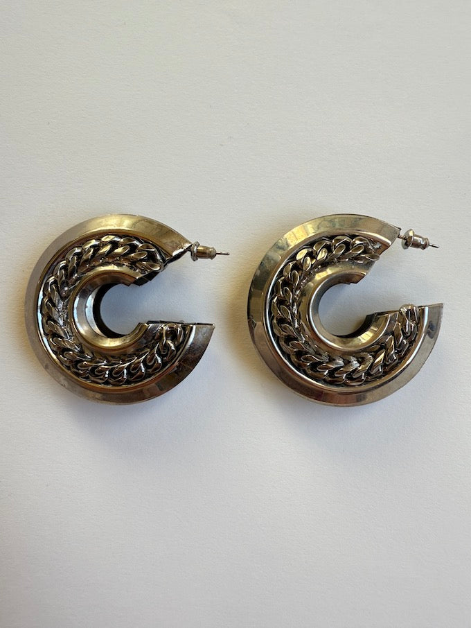 Crescent-shaped hoop earring with a polished silver-tone finish earring