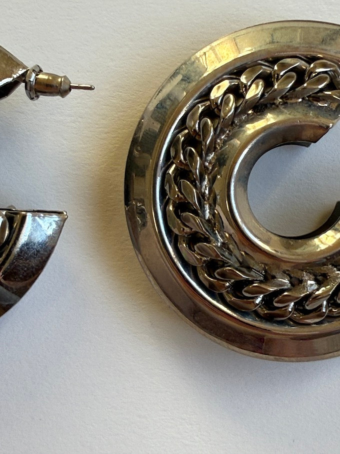 Crescent-shaped hoop earring with a polished silver-tone finish earring