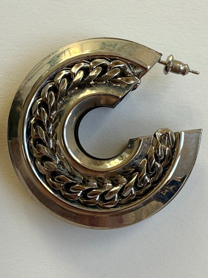 Crescent-shaped hoop earring with a polished silver-tone finish earring