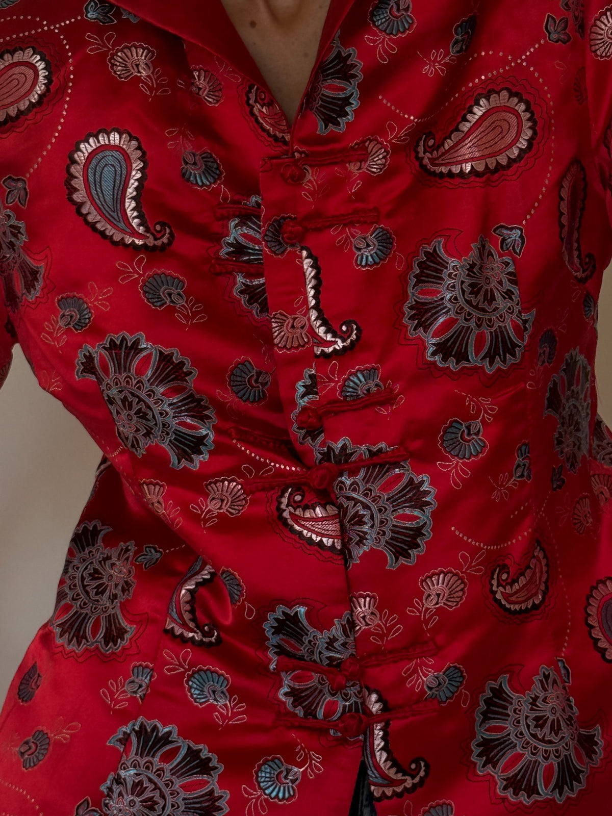 Vintage red satin paisley jacket frog closure close-up