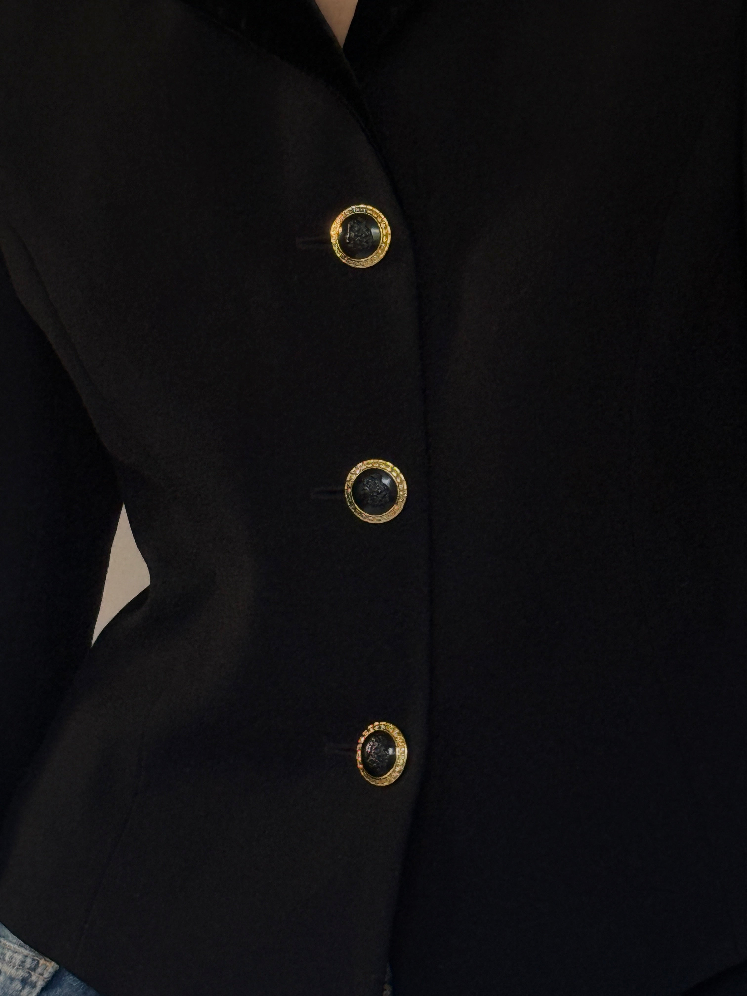 Vintage gold-tone button detail on black blazer