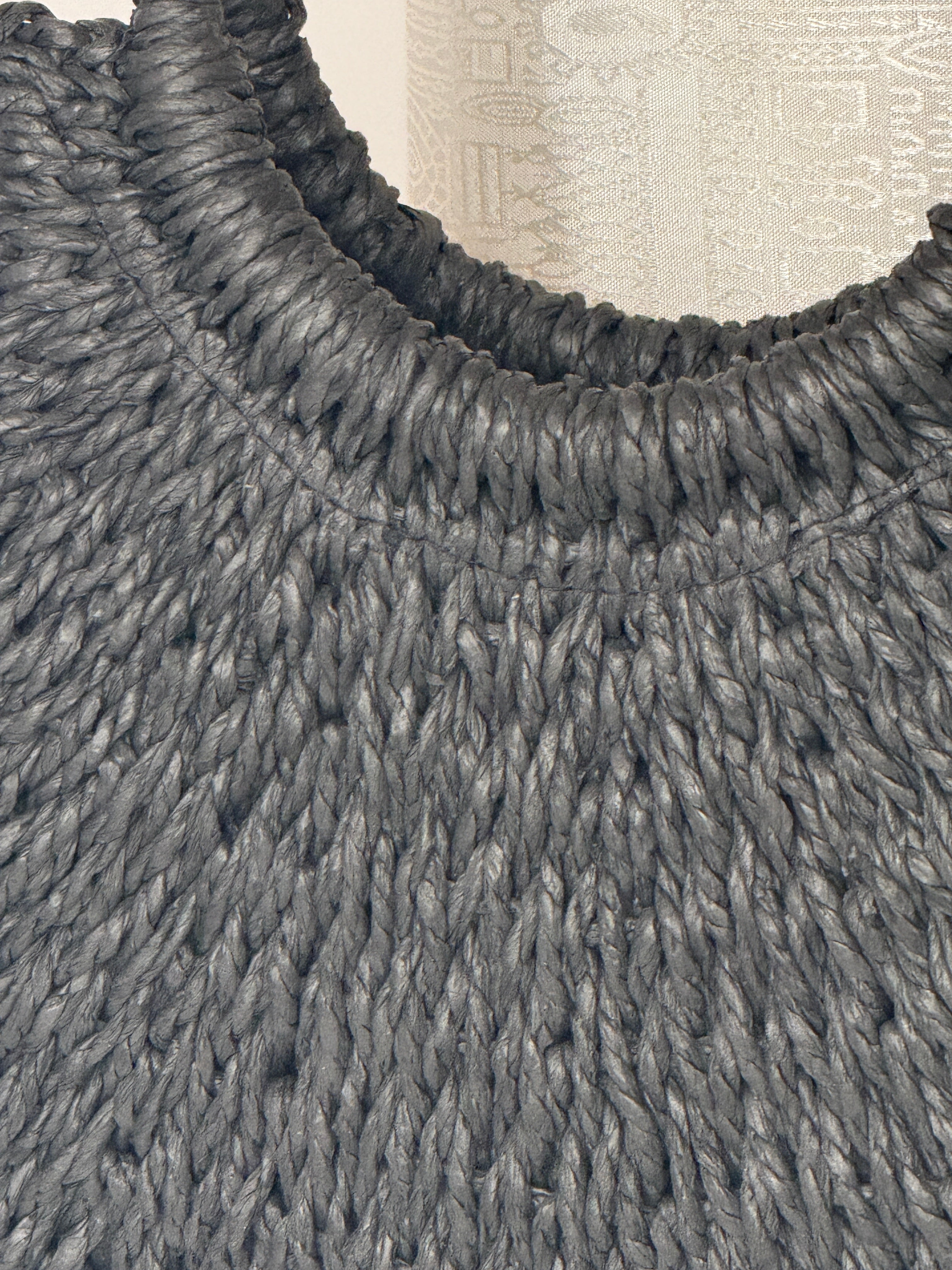 Vintage black woven straw handbag texture close-up