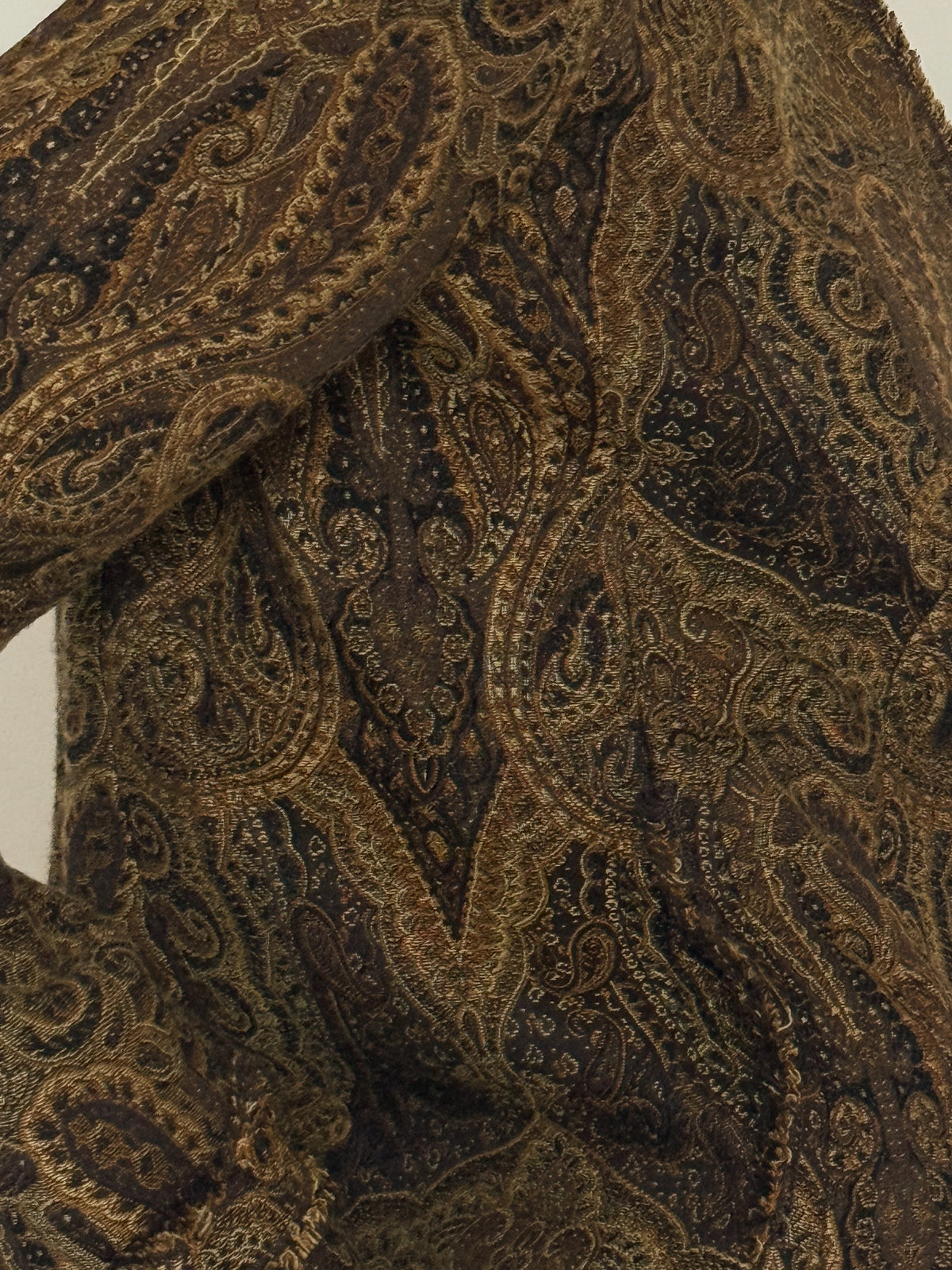 Vintage paisley jacket fabric close-up brown