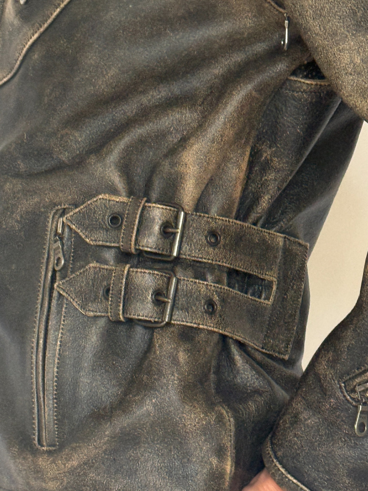 Vintage distressed leather moto jacket buckle detail