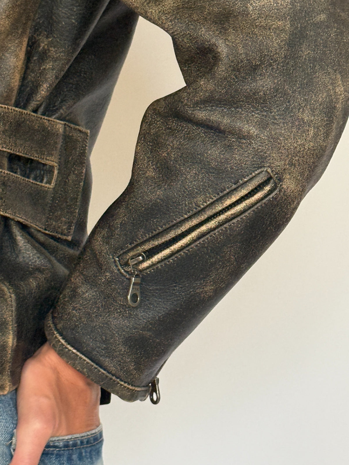 Vintage distressed leather moto jacket sleeve zipper detail